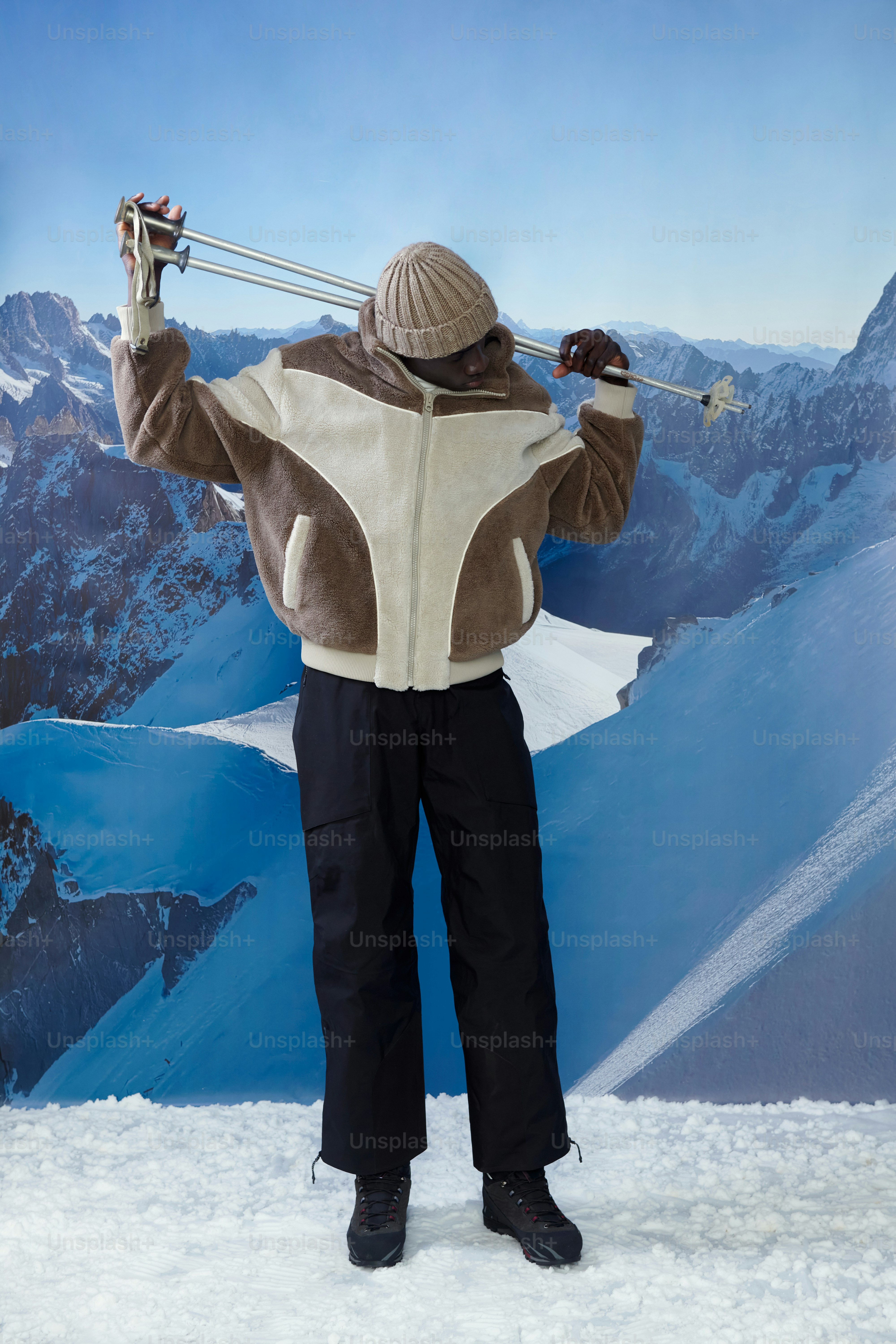 雪山でスキーポールを持つ冬用ジャケット姿のスキーヤー