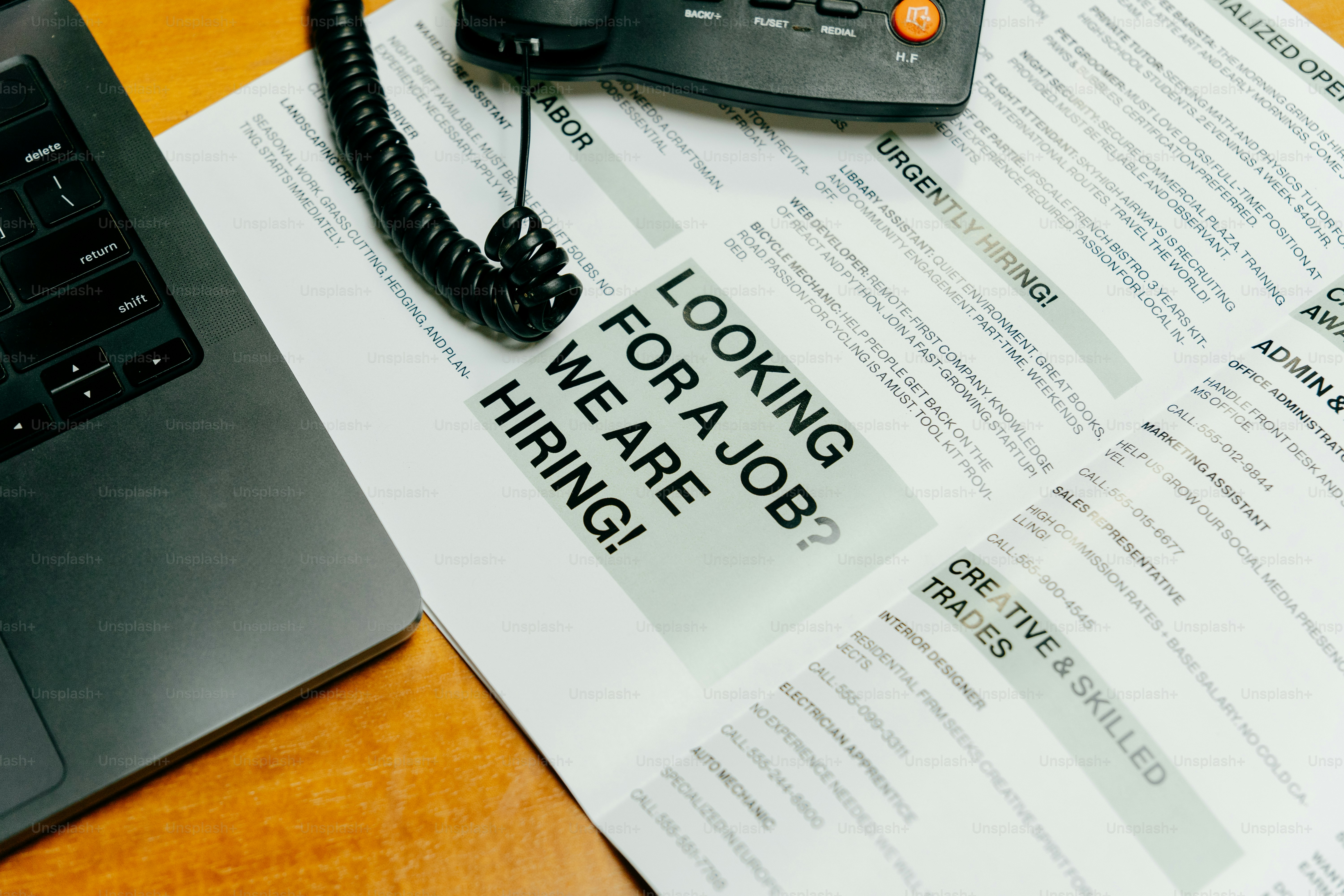 Job advertisement with a phone and laptop.