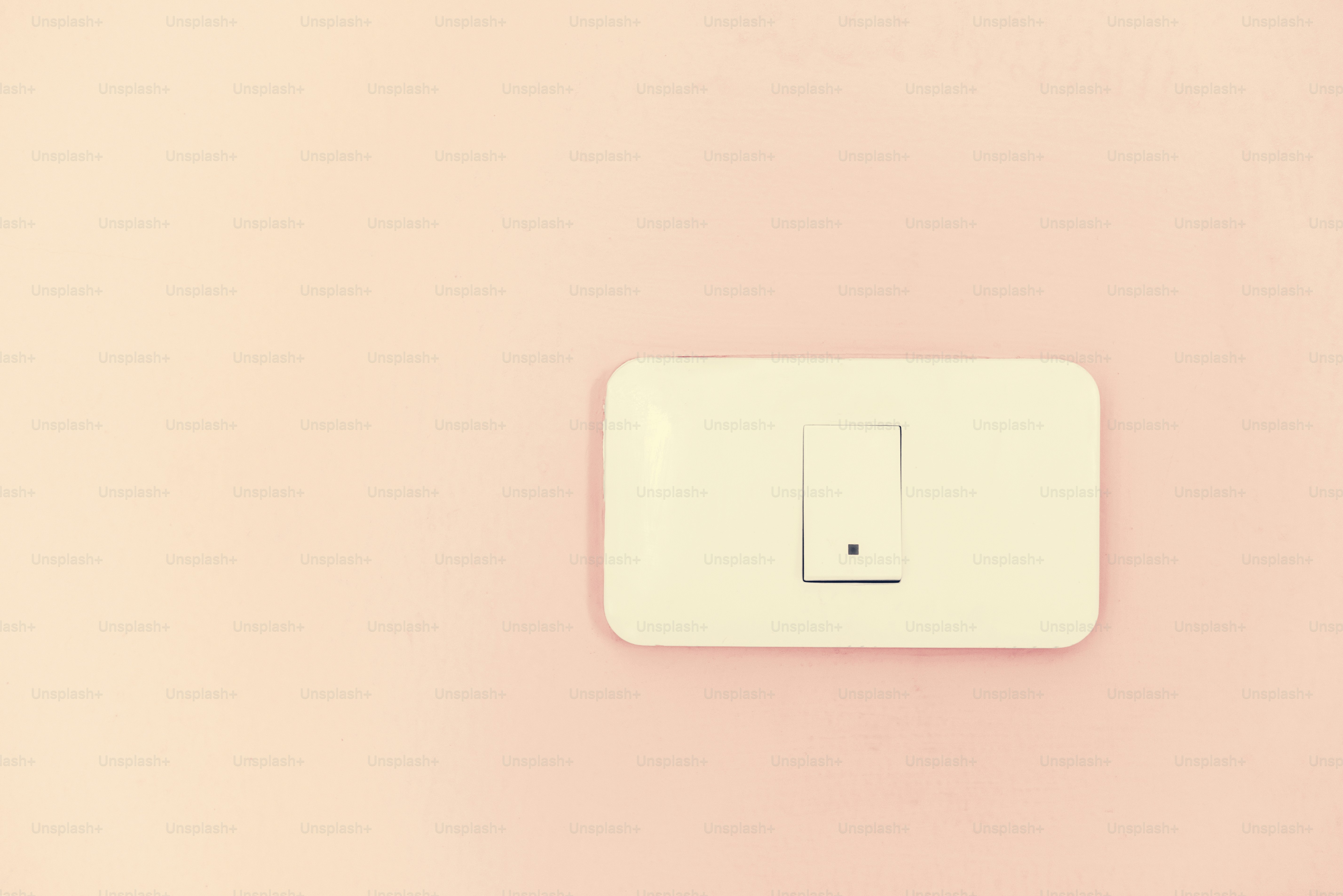 White light switch electric power supply on pink wall