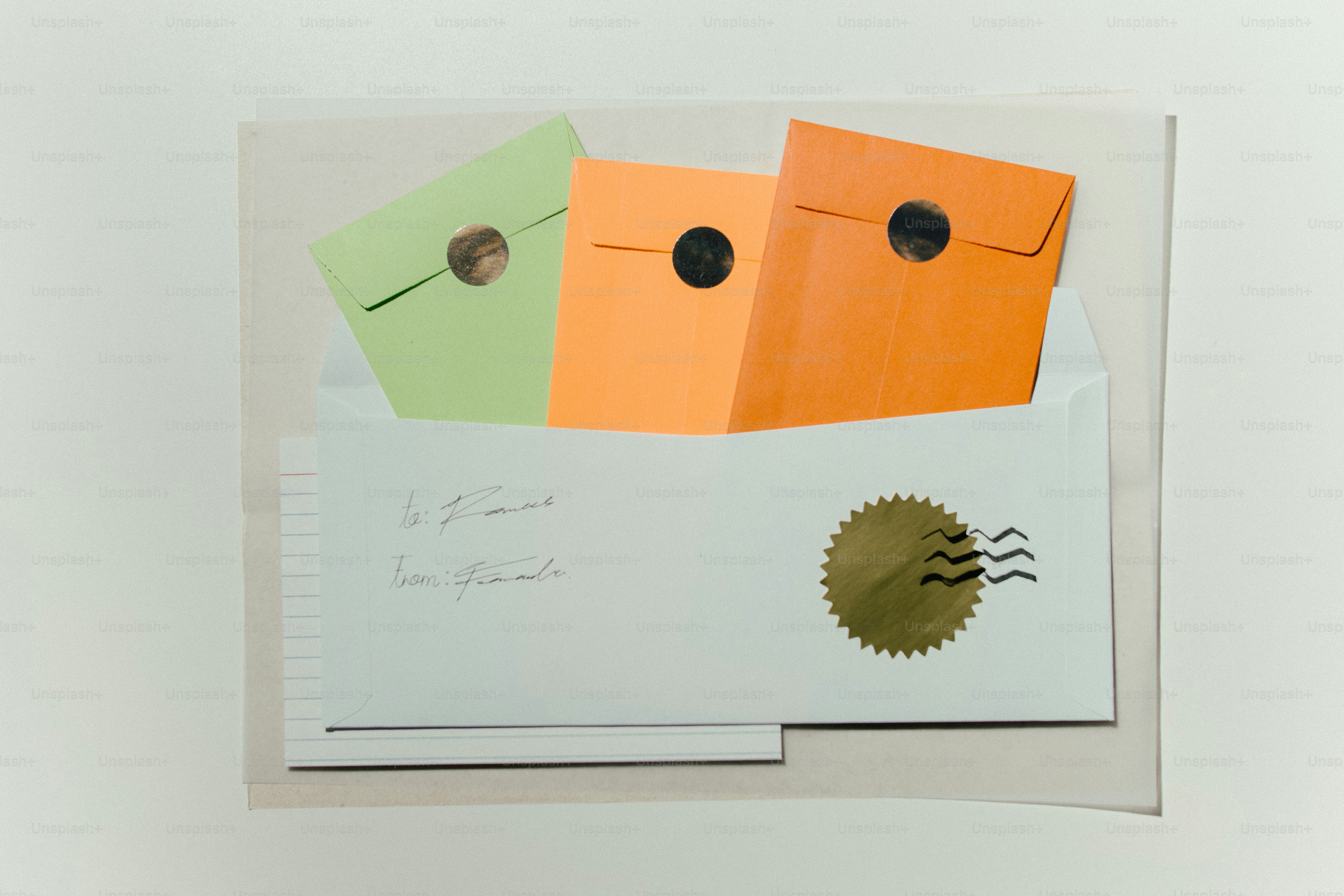 Three colorful envelopes inside a white envelope