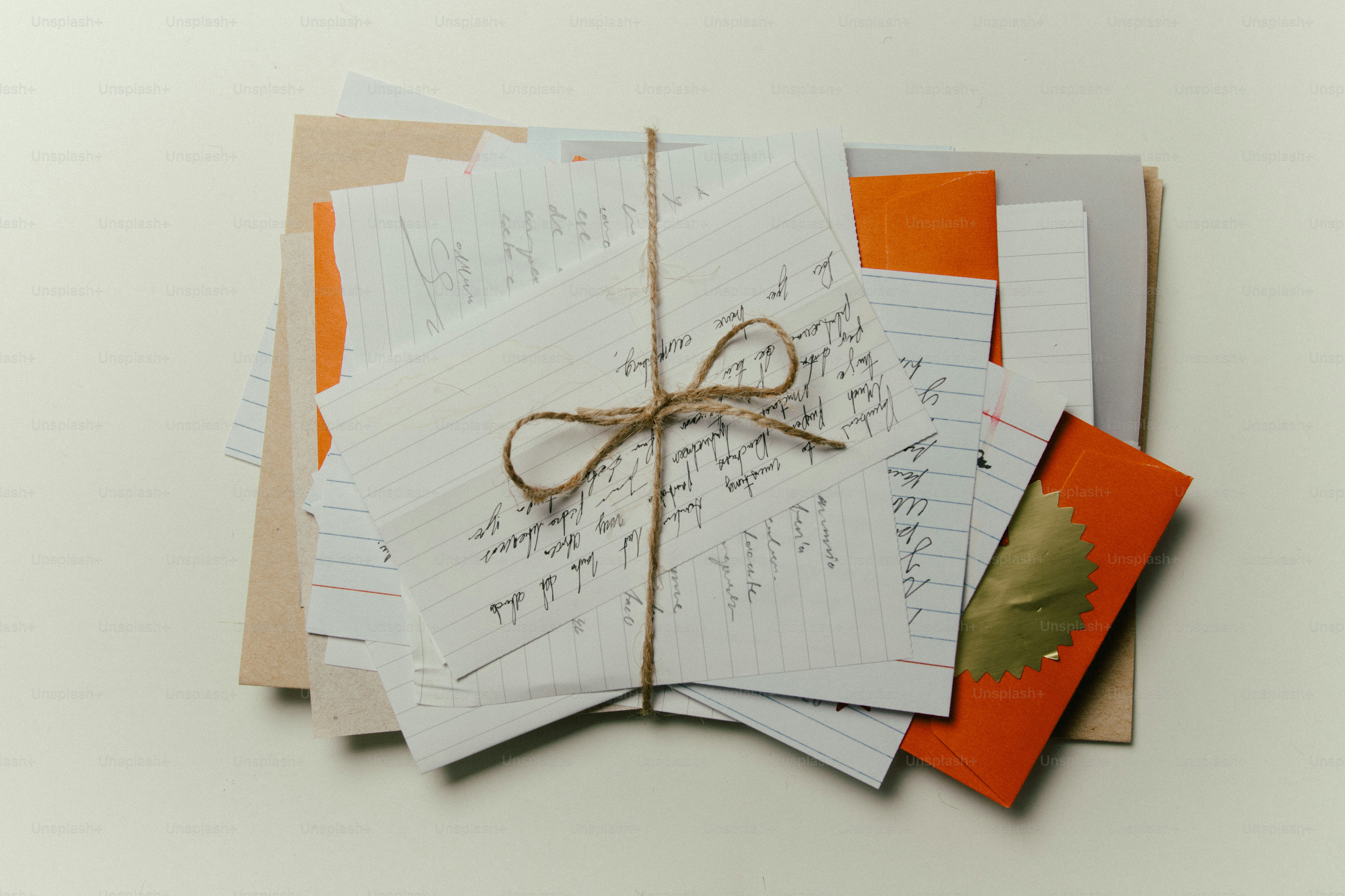 Stack of letters tied with twine on a light background