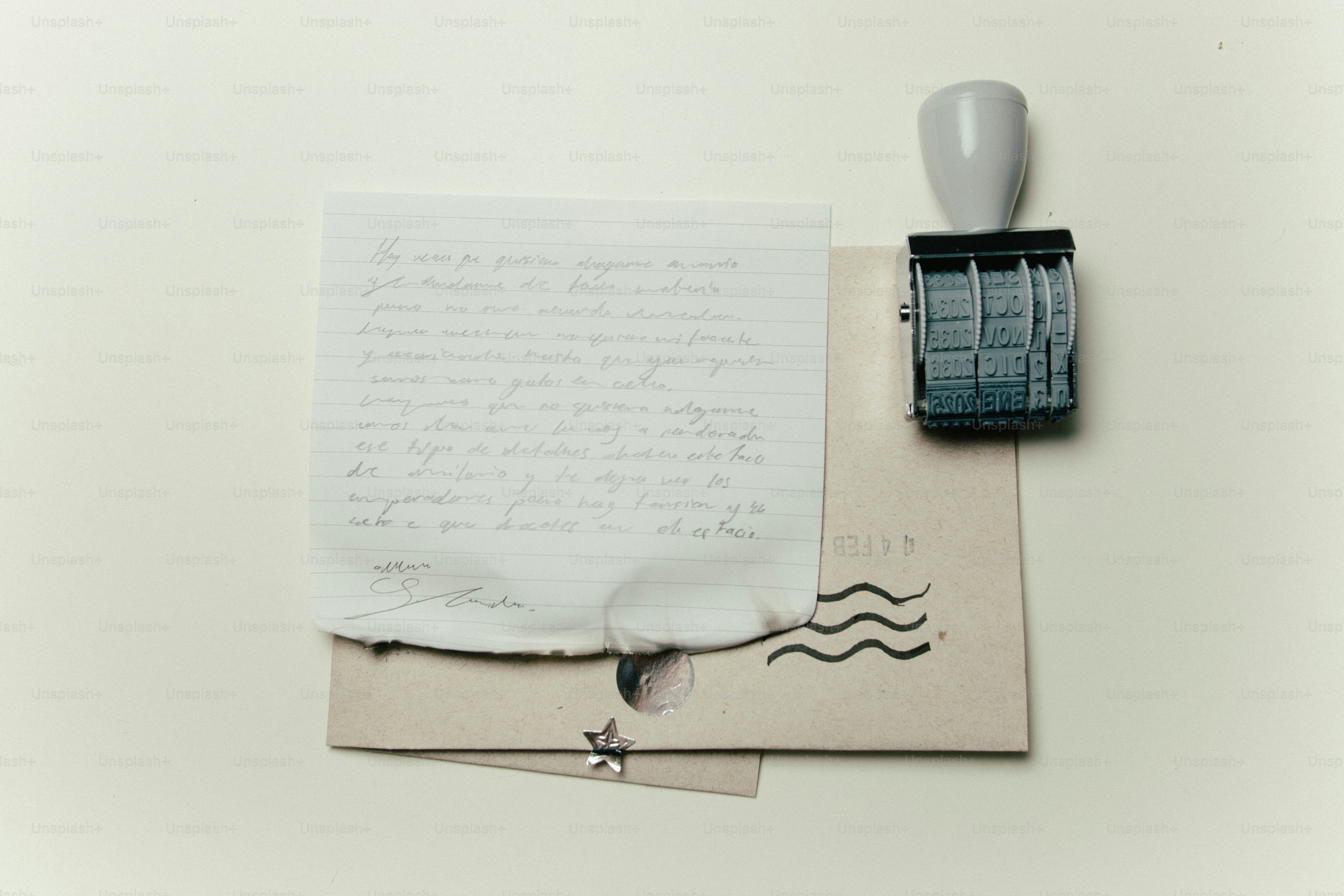A burnt letter with a rubber stamp and envelope