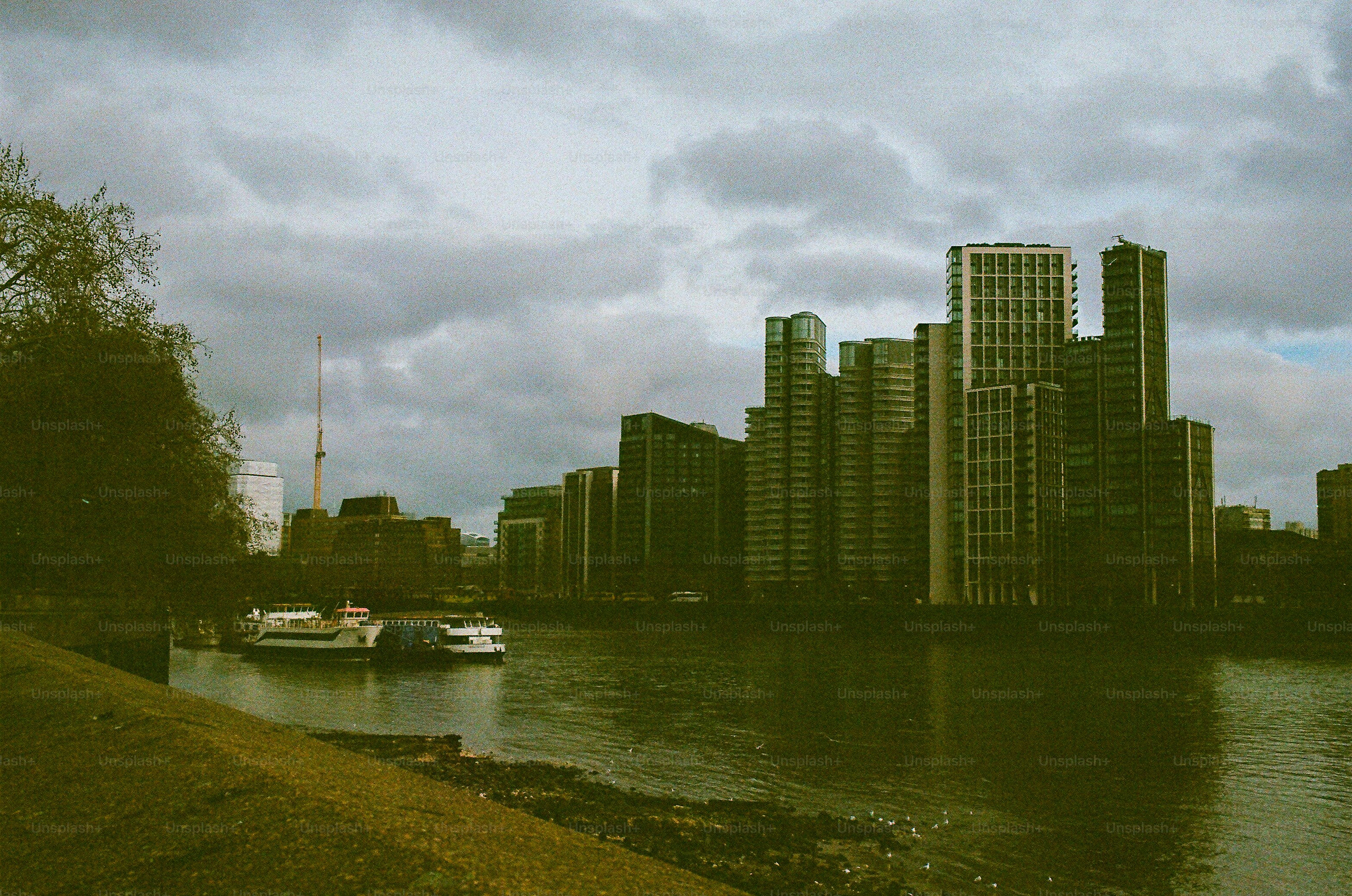 City skyline with boats on the river.