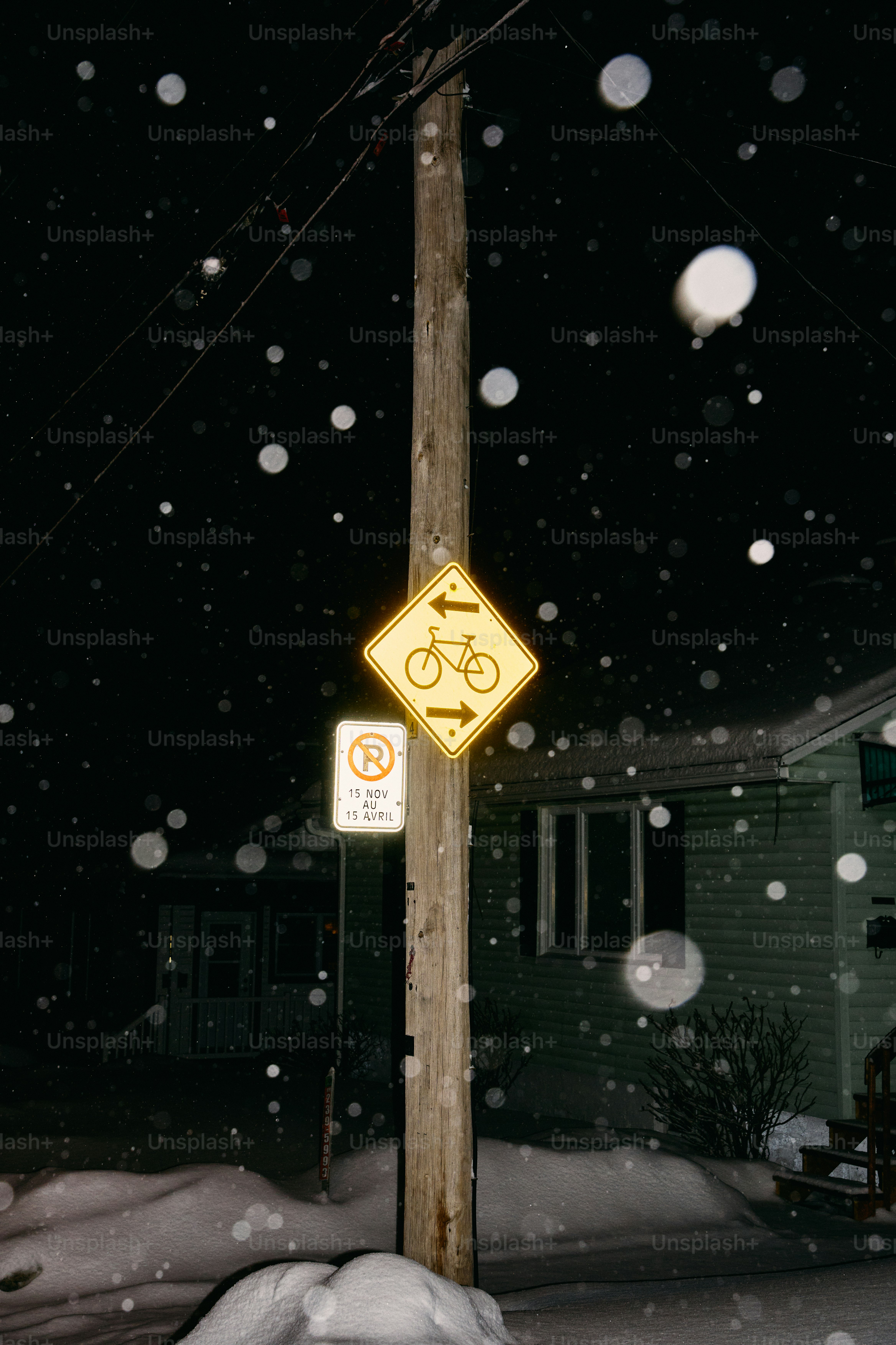 Bicycle lane sign on pole at night