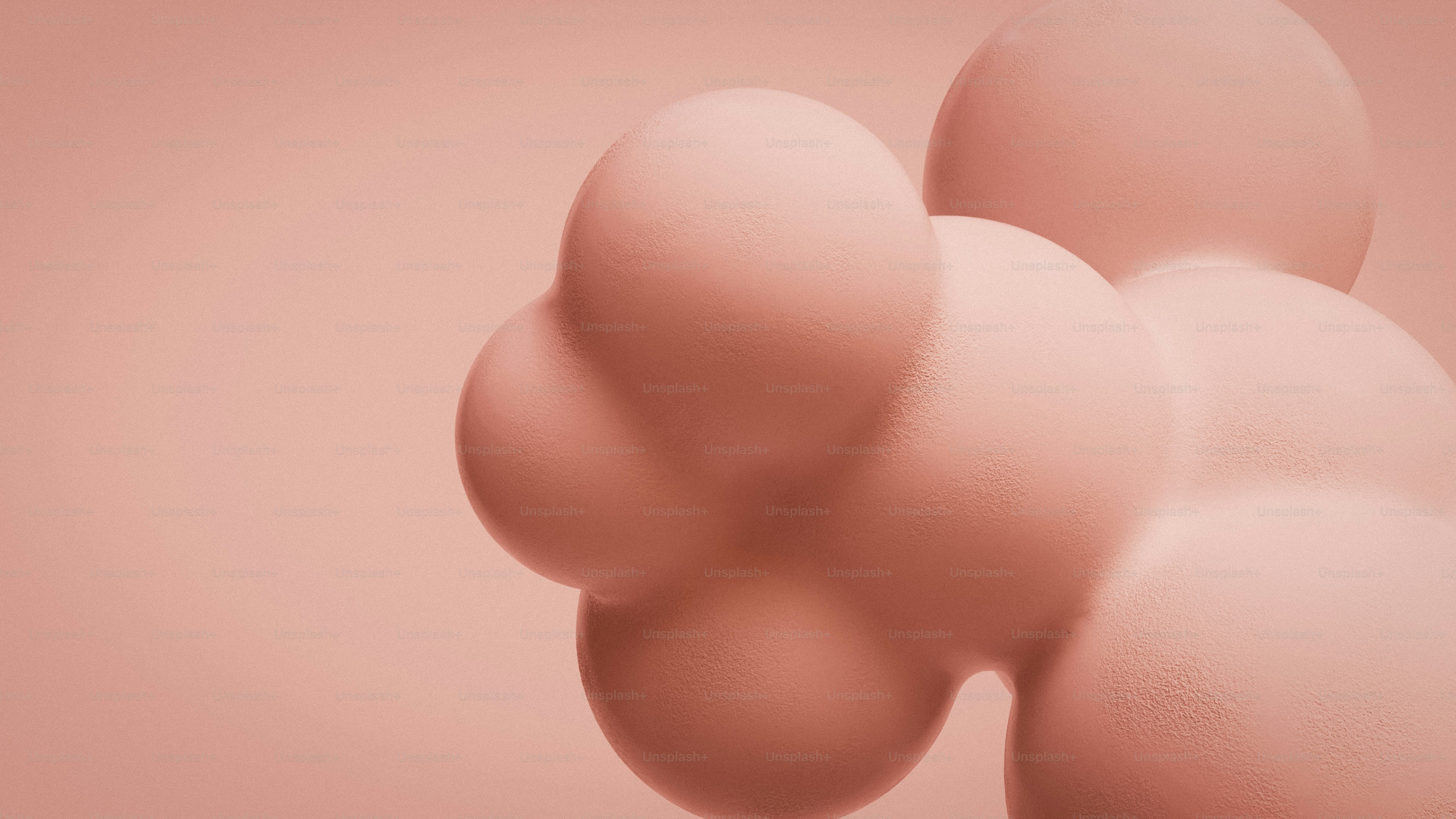 부드러운 분홍색 구체들이 연한 분홍색 배경 위에 모여 있다