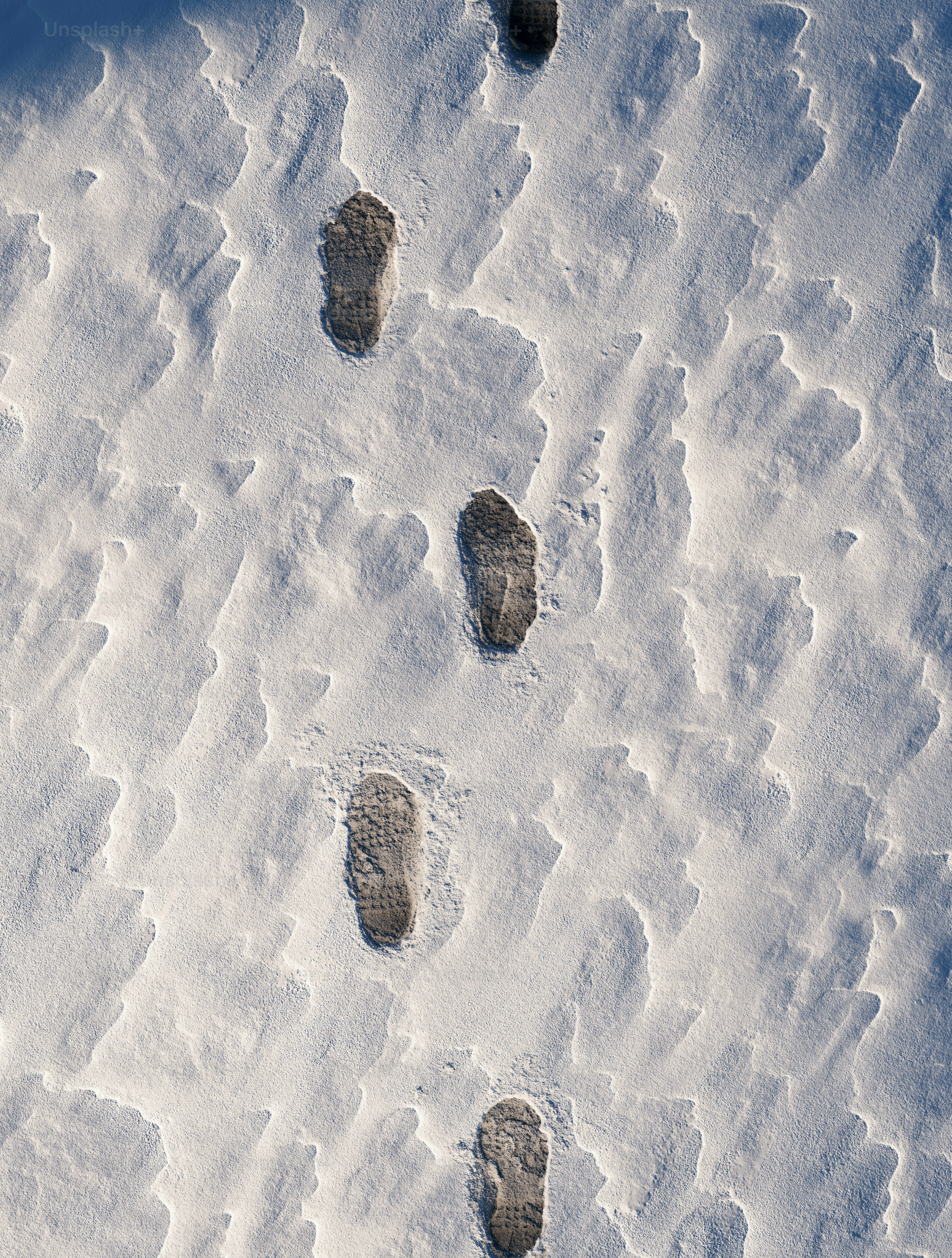 Footprints in the snow on a winter day photo – Travel Image on Unsplash