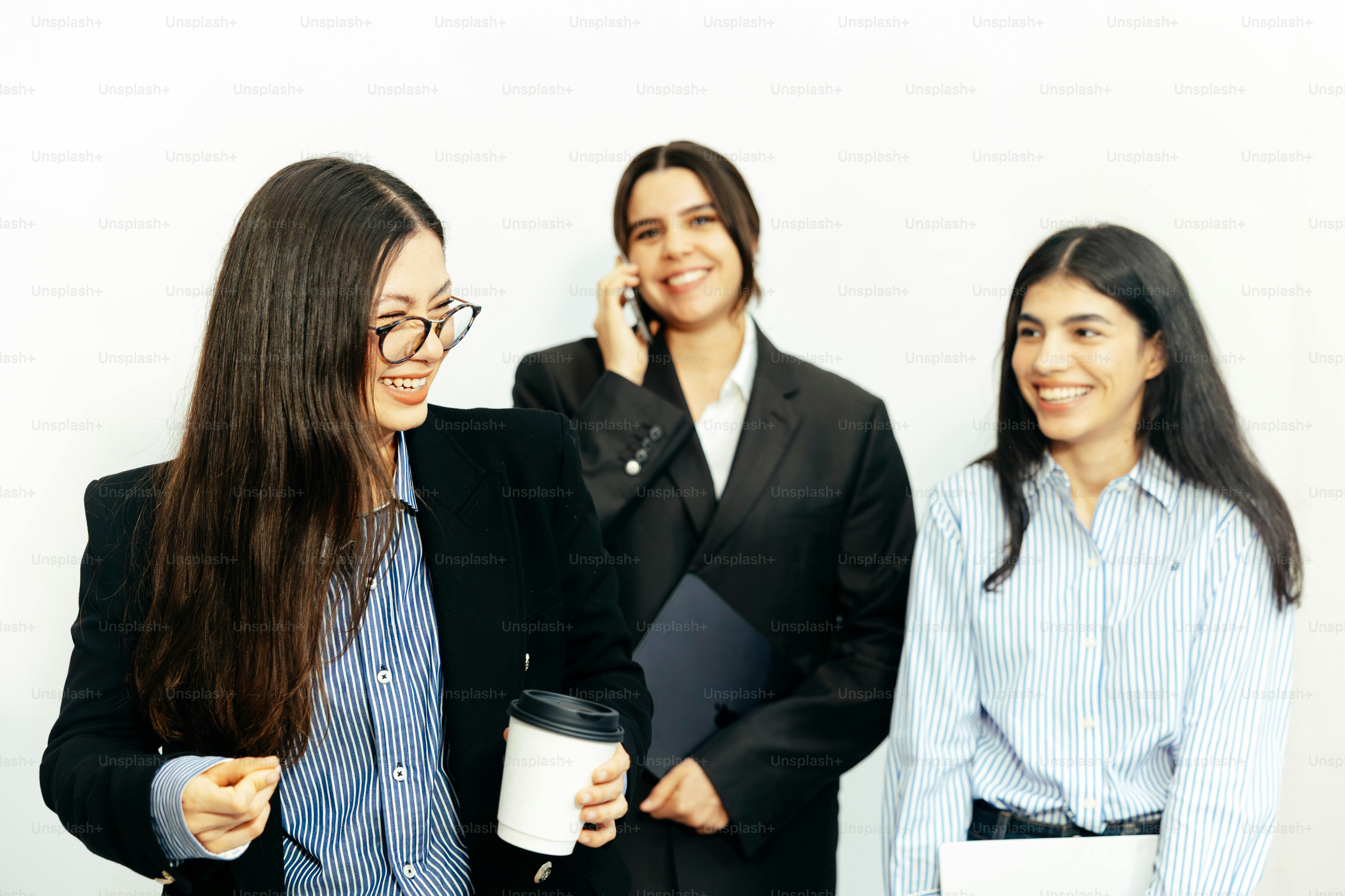 Three women in business attire smiling photo – Teamwork Image on Unsplash