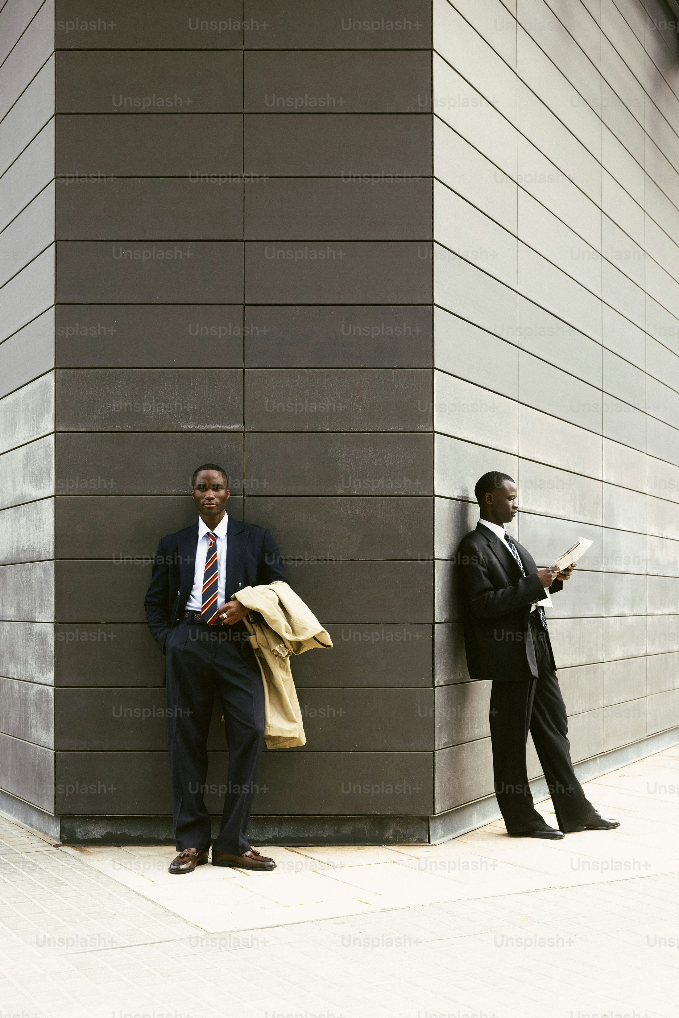 Two businessmen standing outside modern building