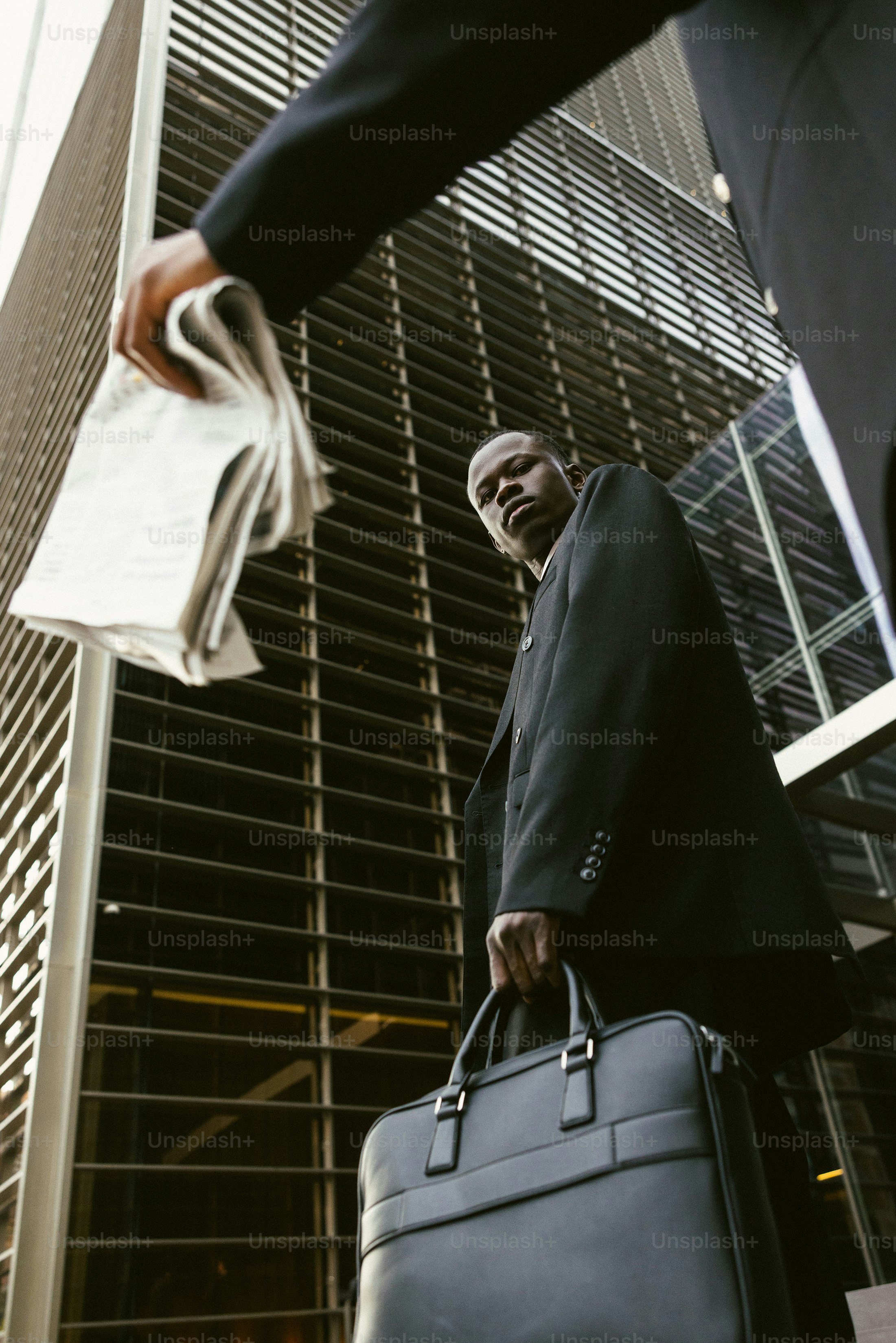 Man in suit carrying briefcase and newspaper