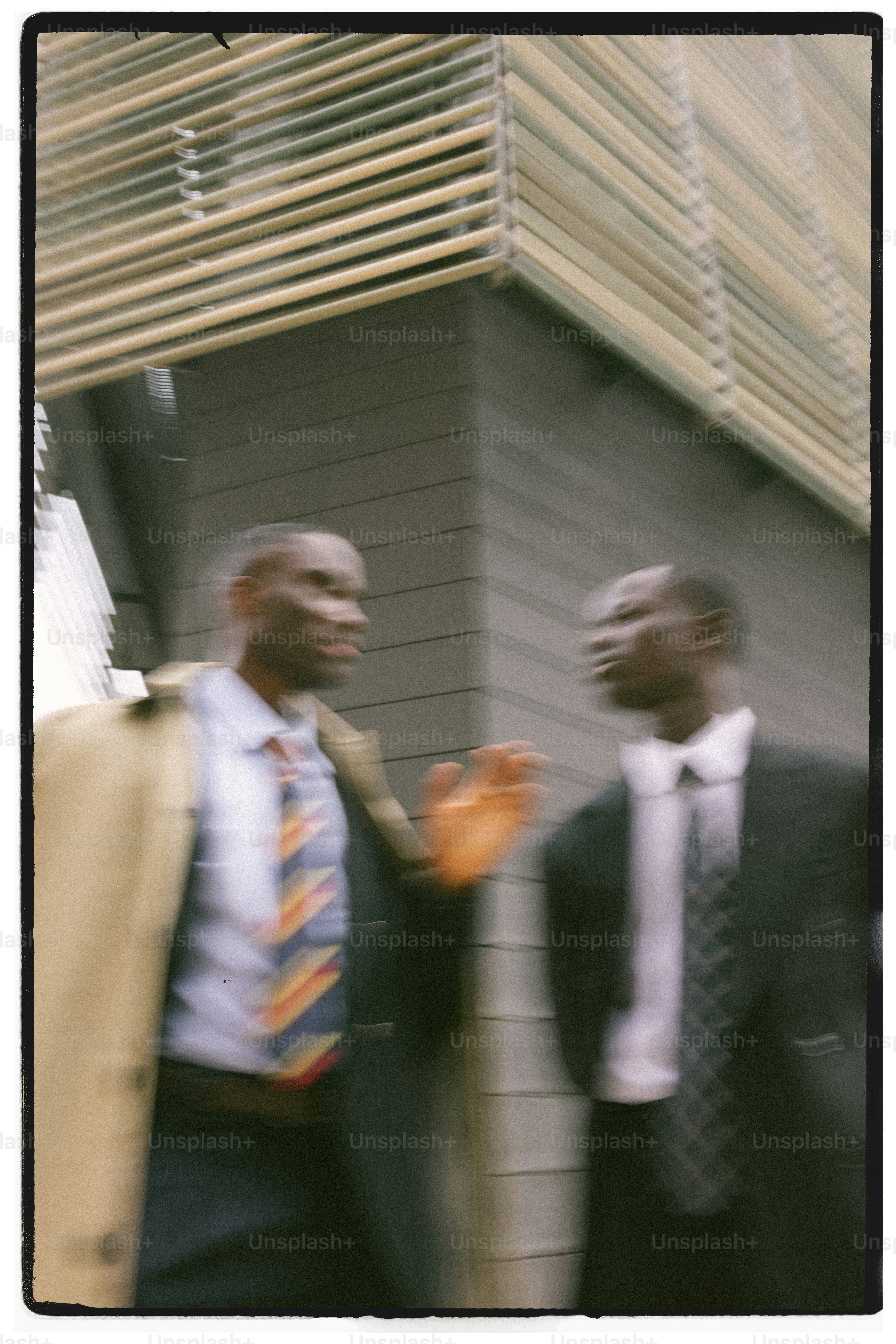 Two businessmen talking outside modern building
