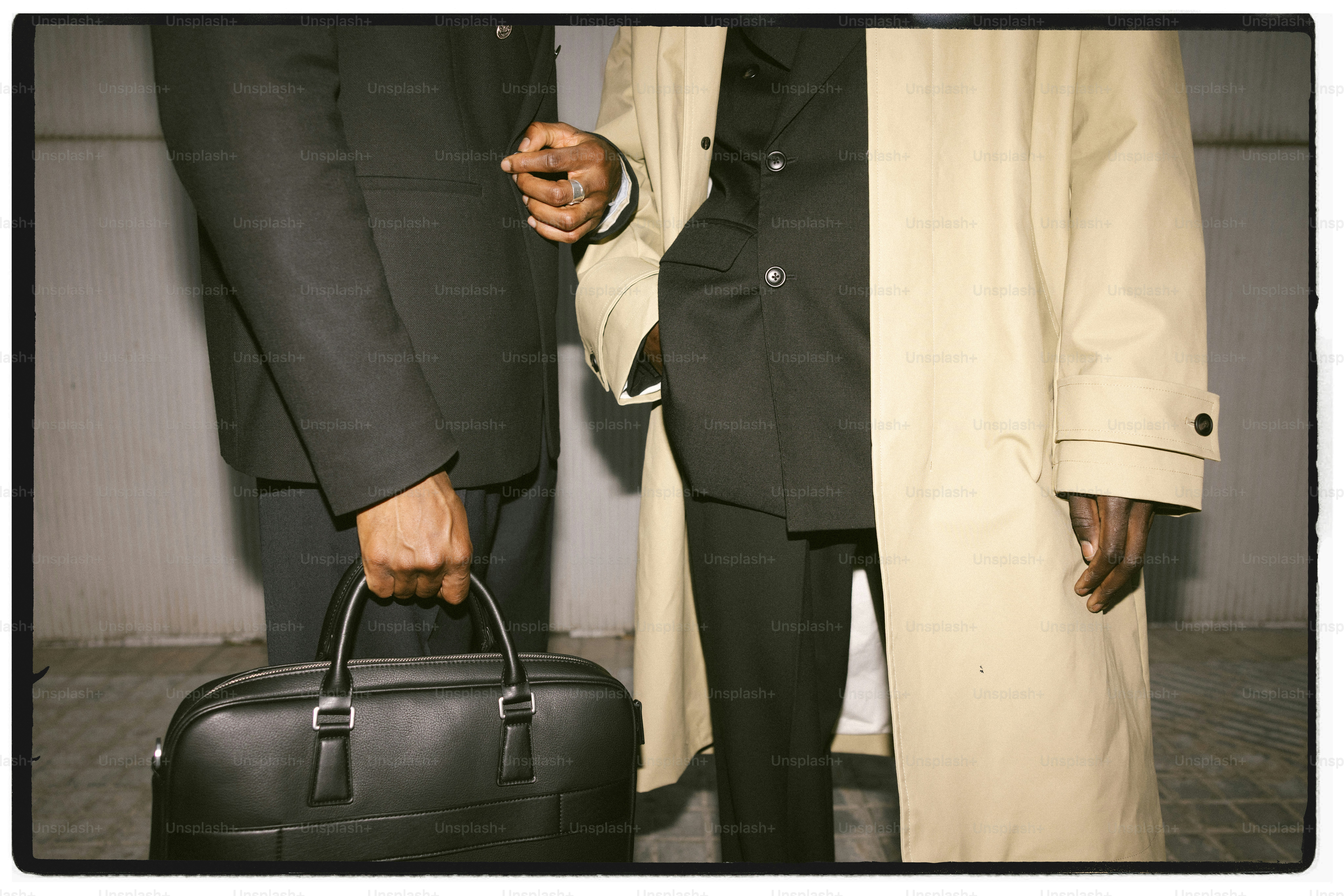 Two men in suits with a briefcase