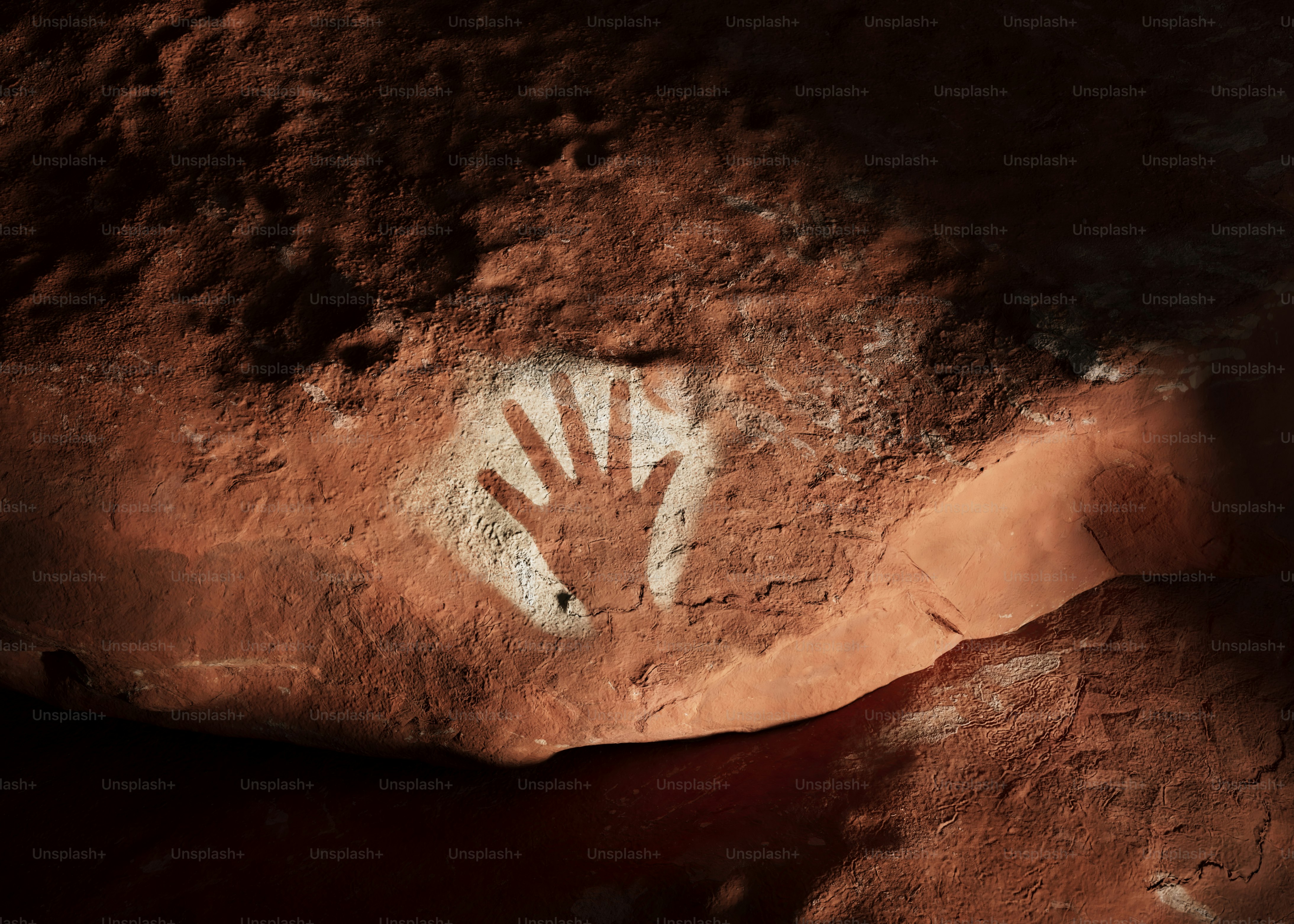 Cave painting of a handprint on a rock