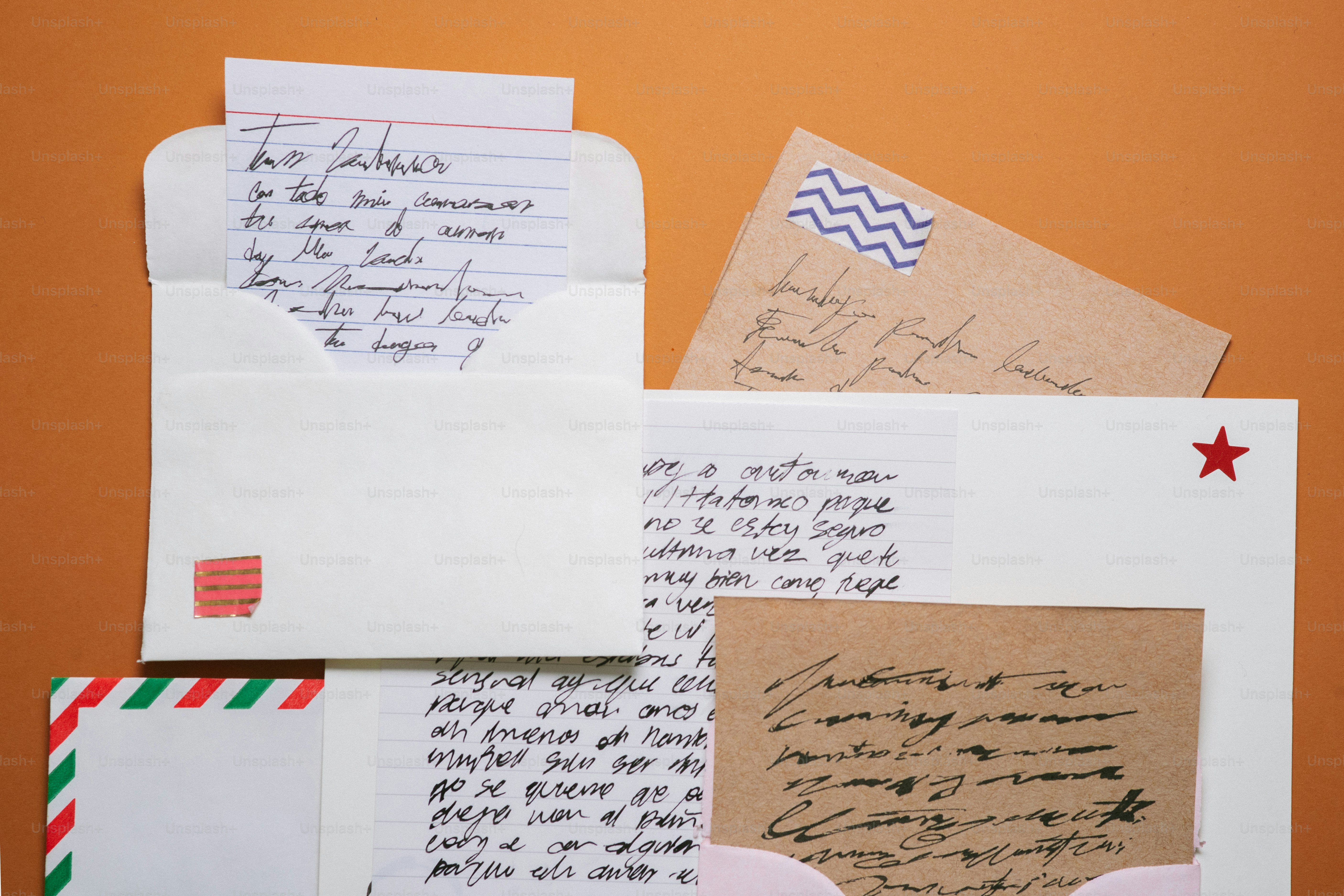 Letters and envelopes arranged on an orange background.