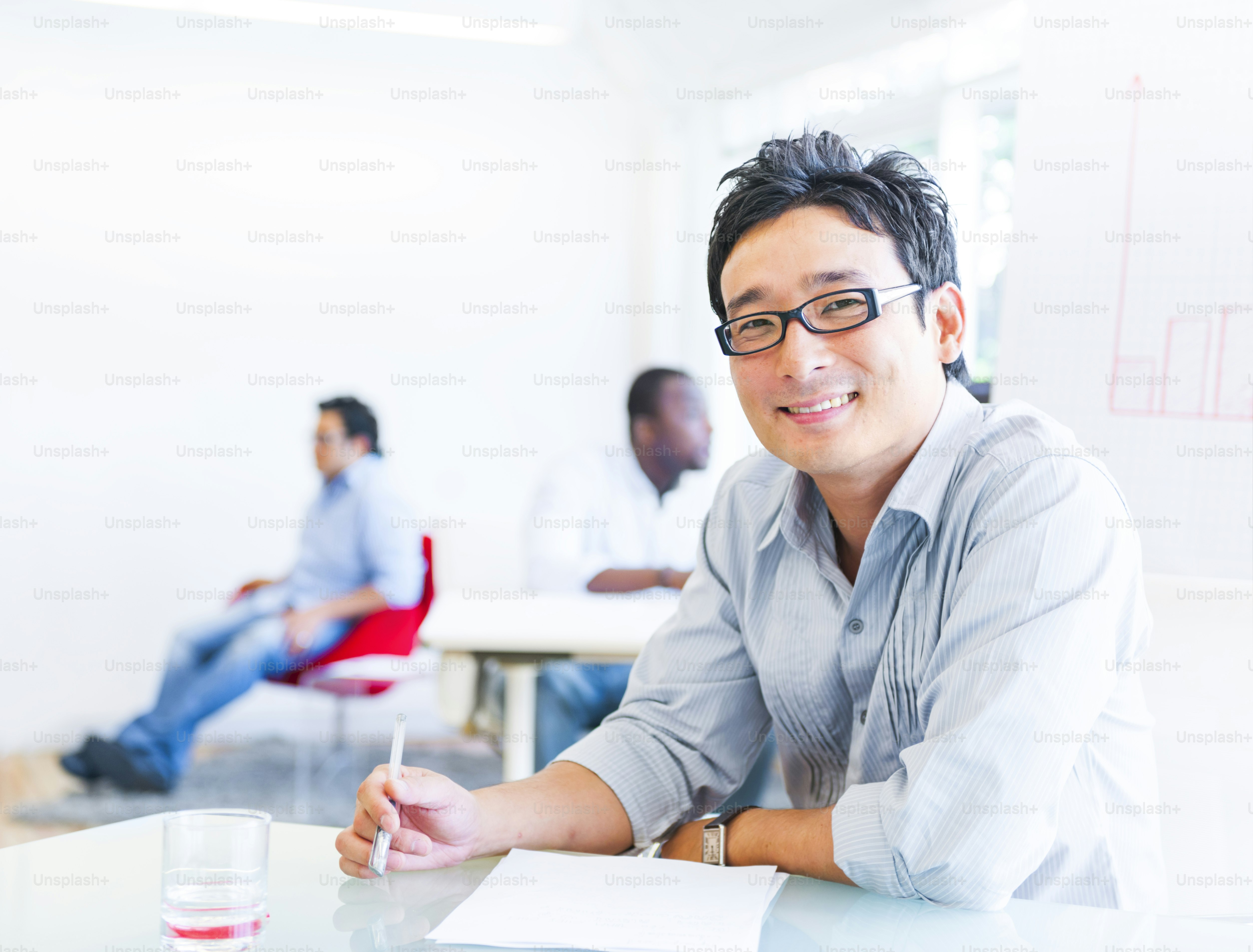 Cheerful Asian Businessman Working with his Paper Works