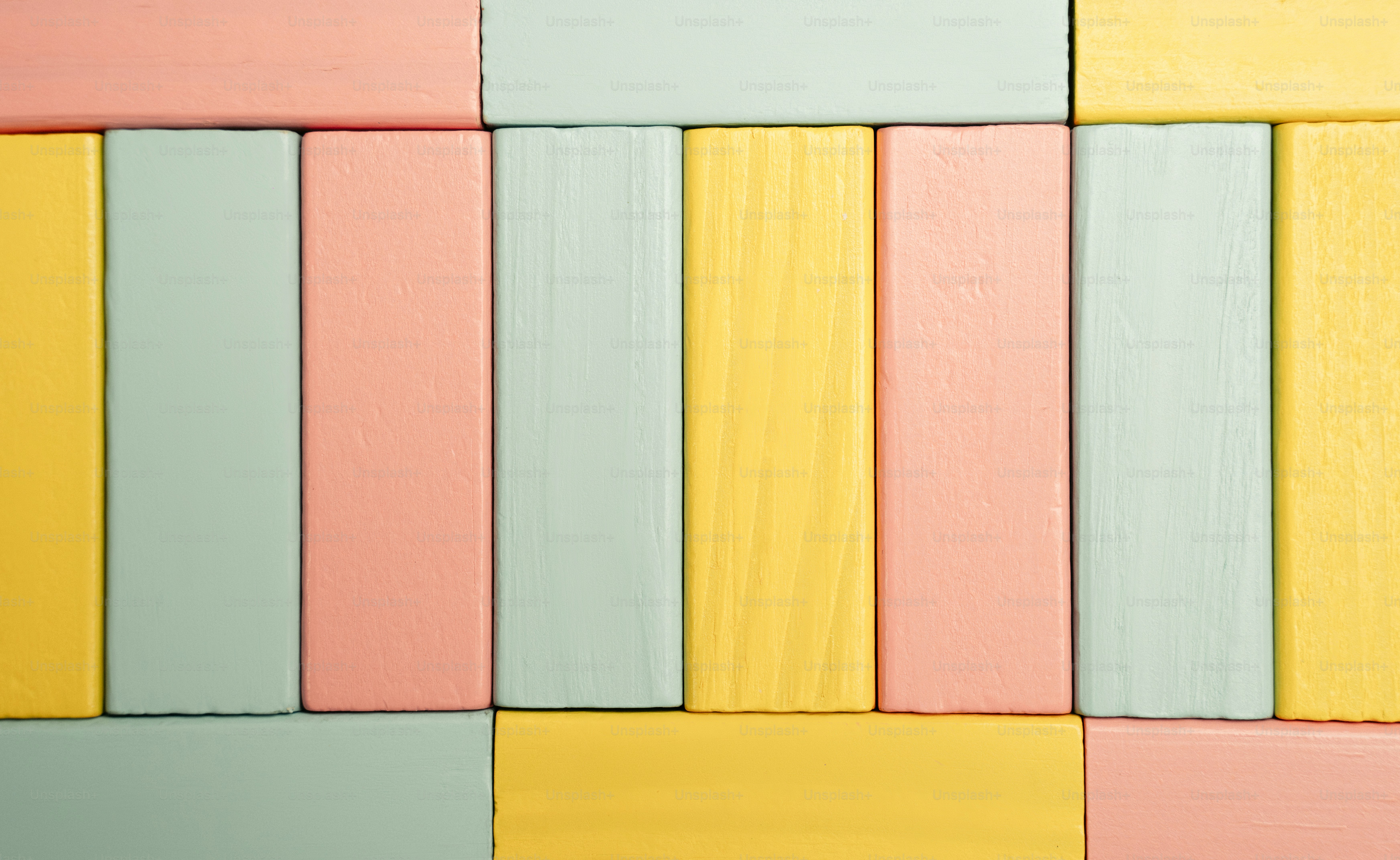 Pastel colored wooden blocks arranged in rows.