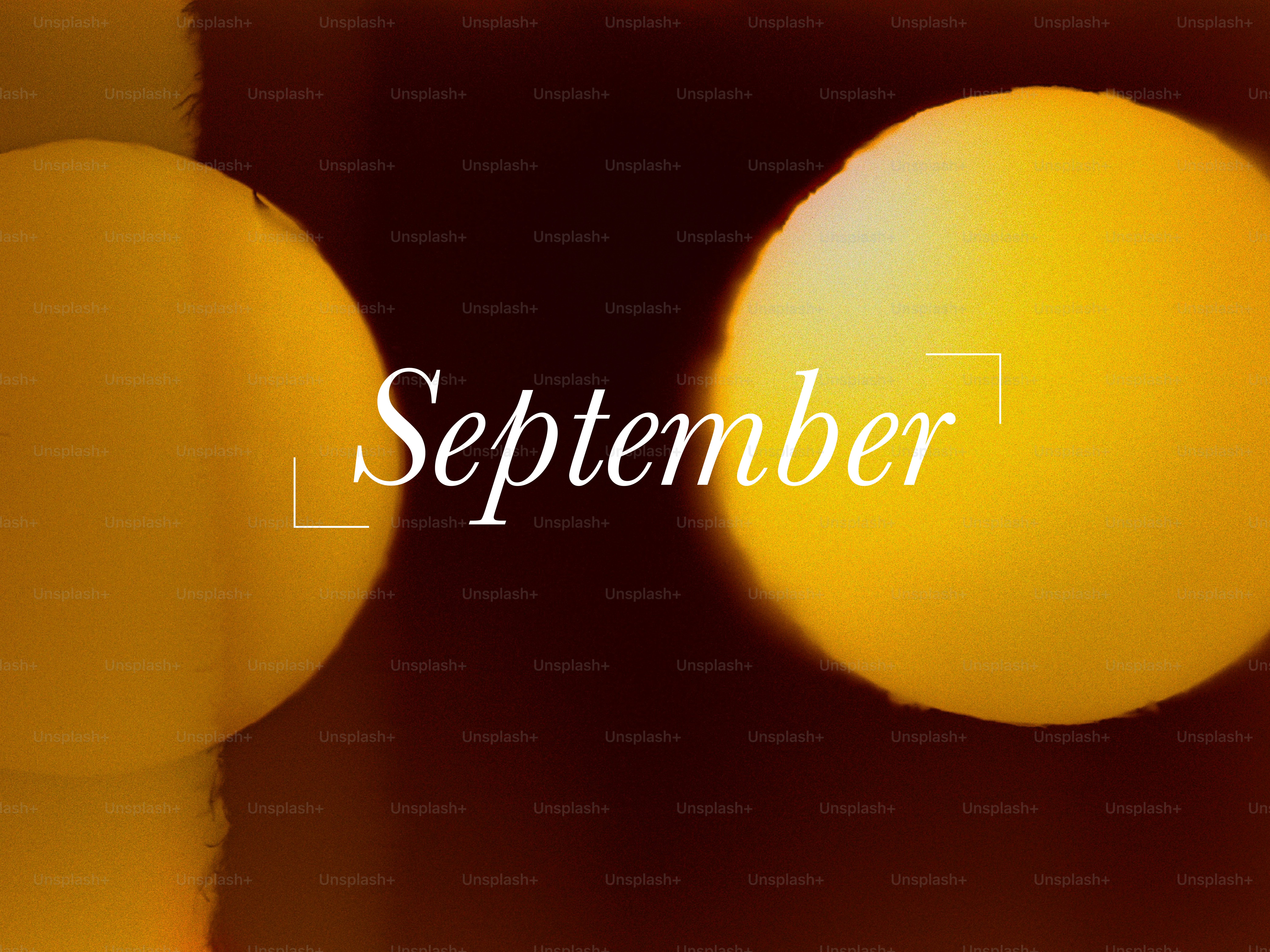 The word september written on a blurred background