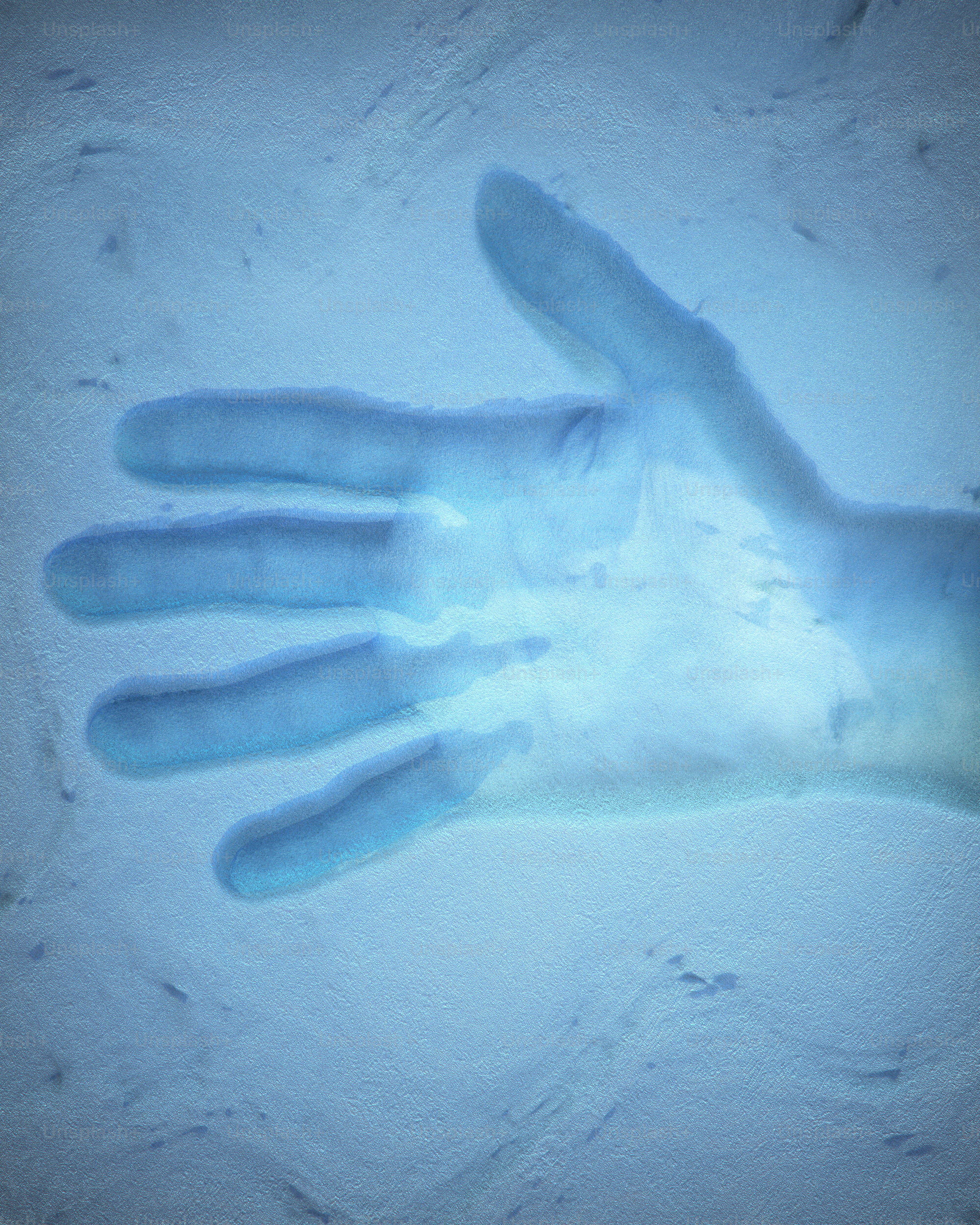 A glowing hand with blue light in the dark