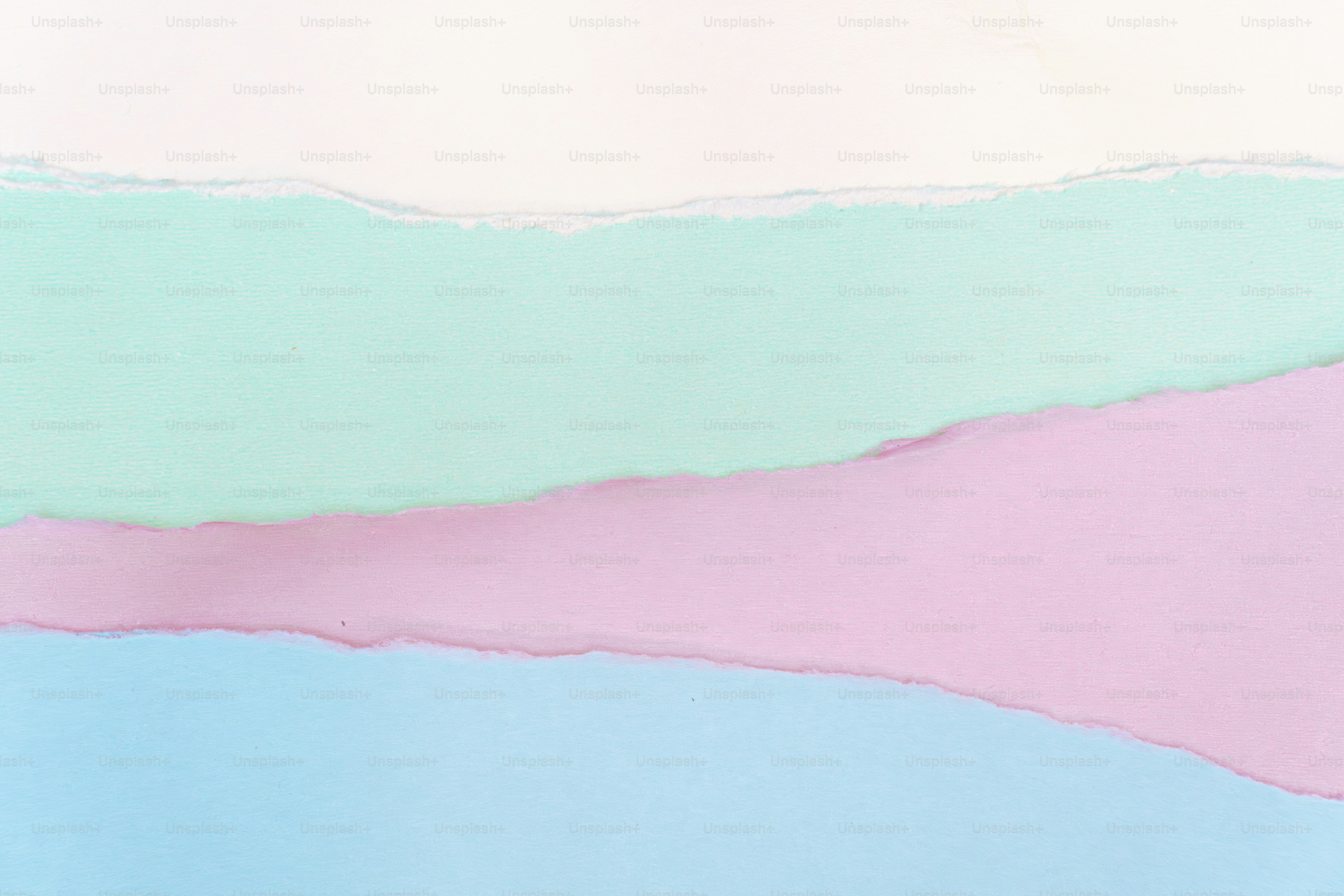 Torn pastel paper layers in soft colors
