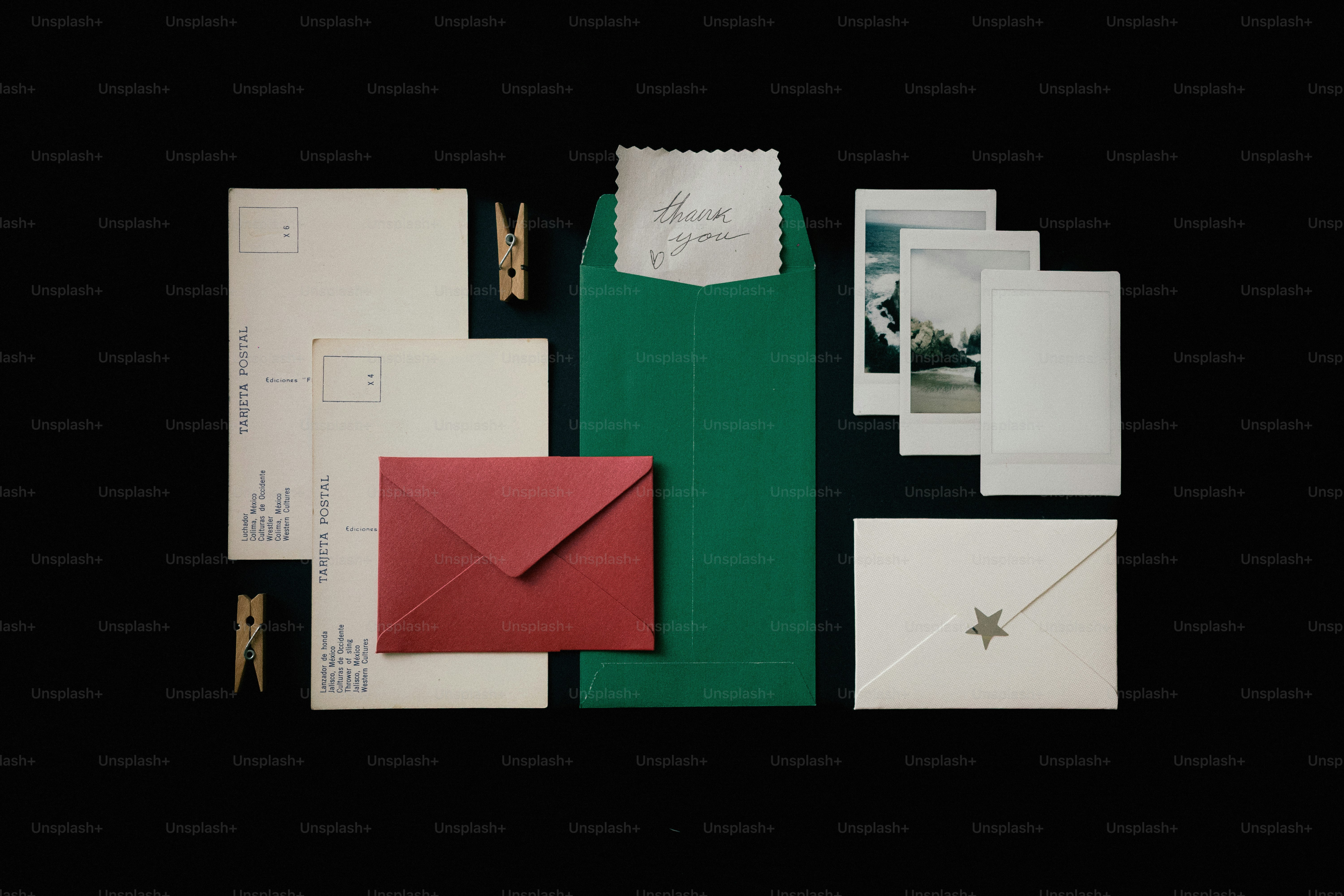 Collection of photos, envelopes, and frames on black background photo ...