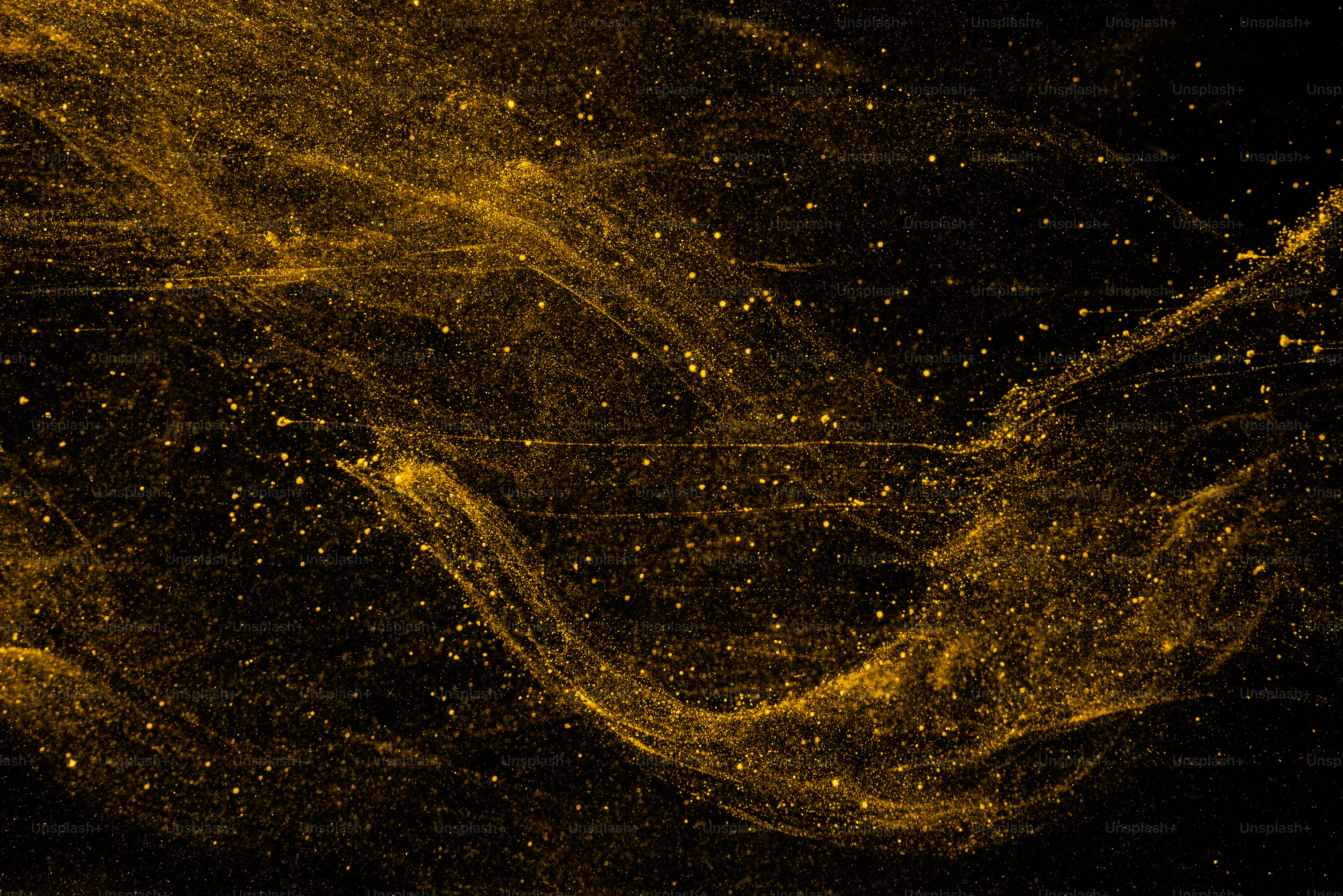 Golden particles swirling in dark fluid photo – Wallpaper Image on Unsplash