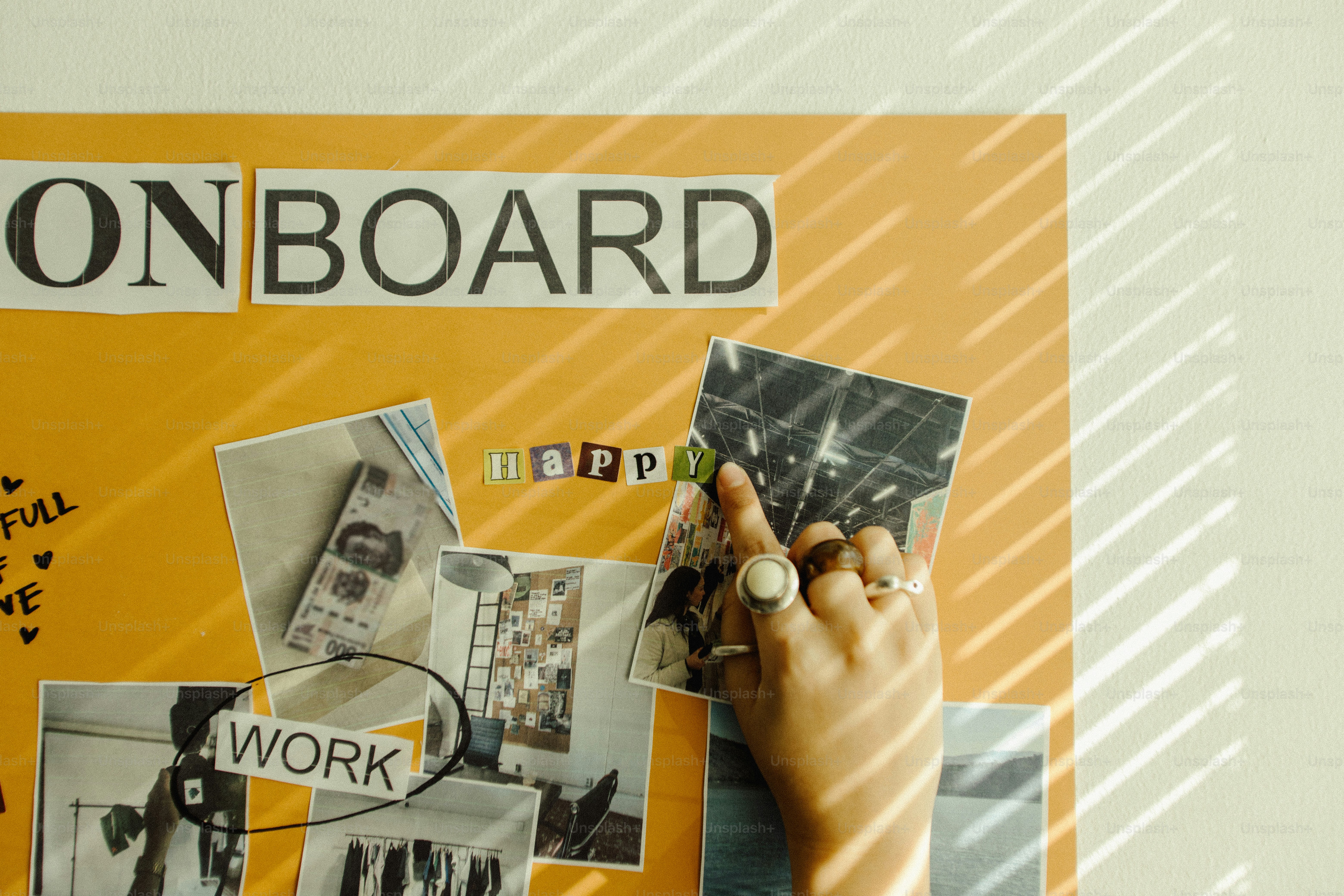 Hand adding photo to a vision board