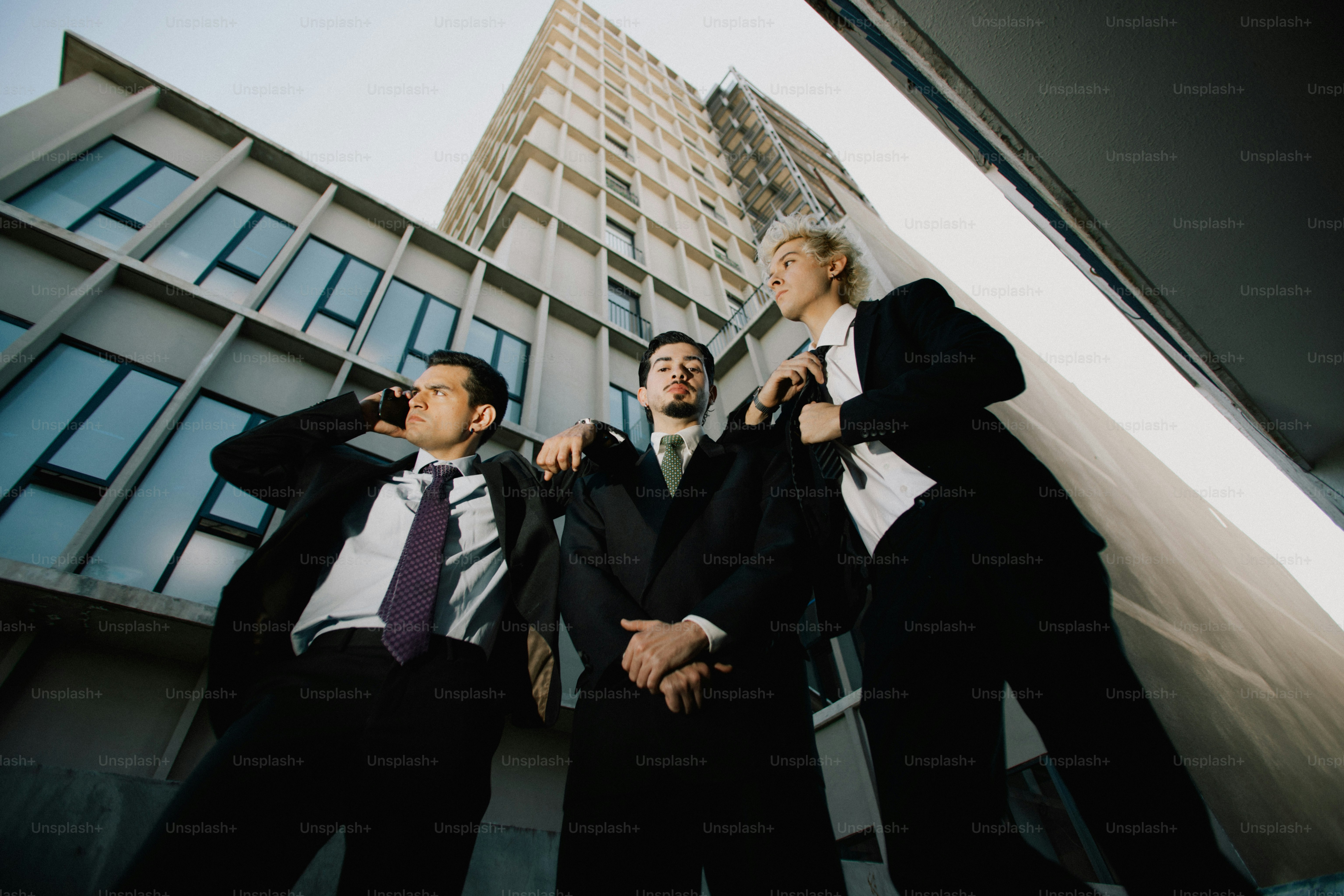 Three men in suits standing in front of a building photo – Teamwork ...
