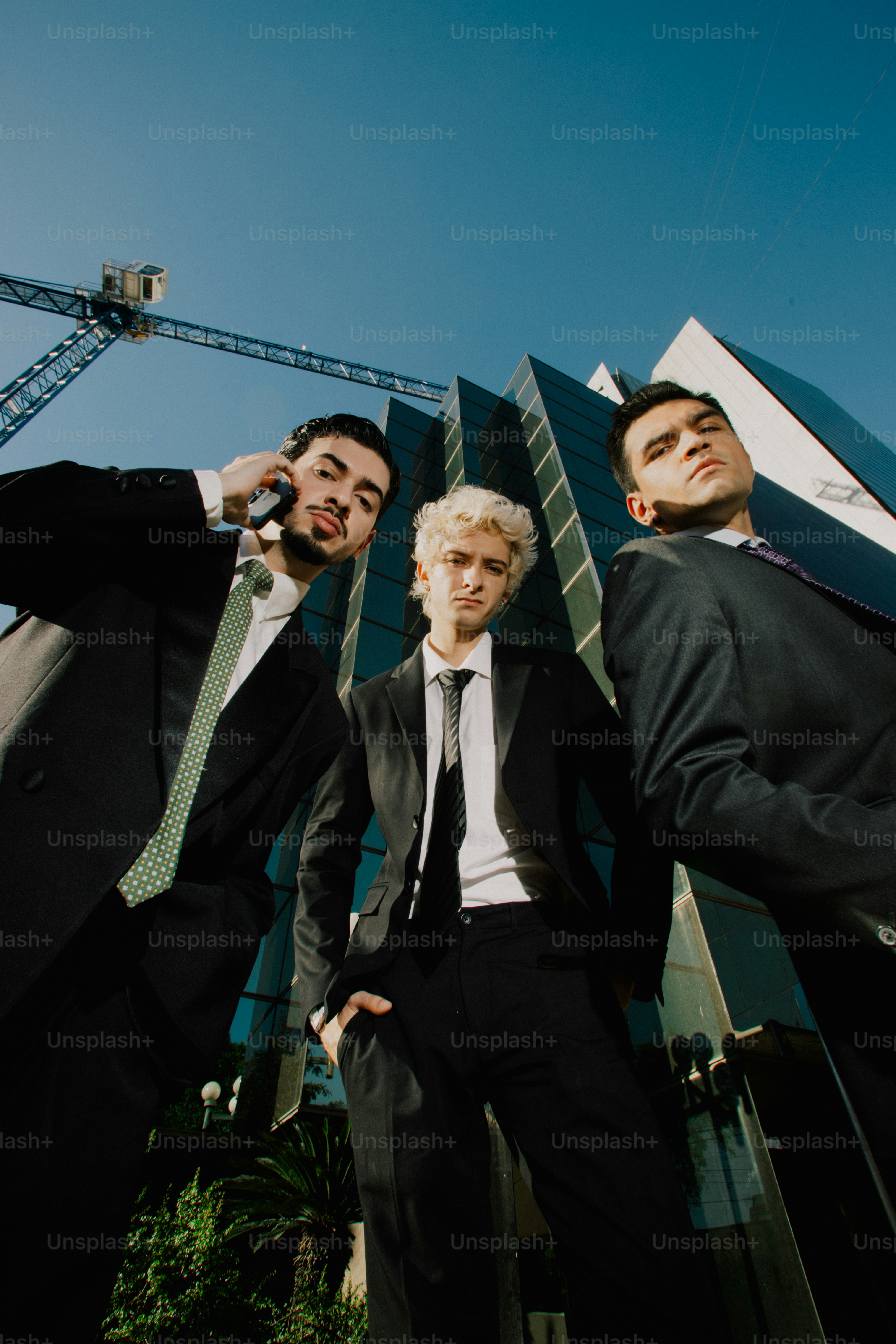 Three businessmen in suits standing outside office building photo ...