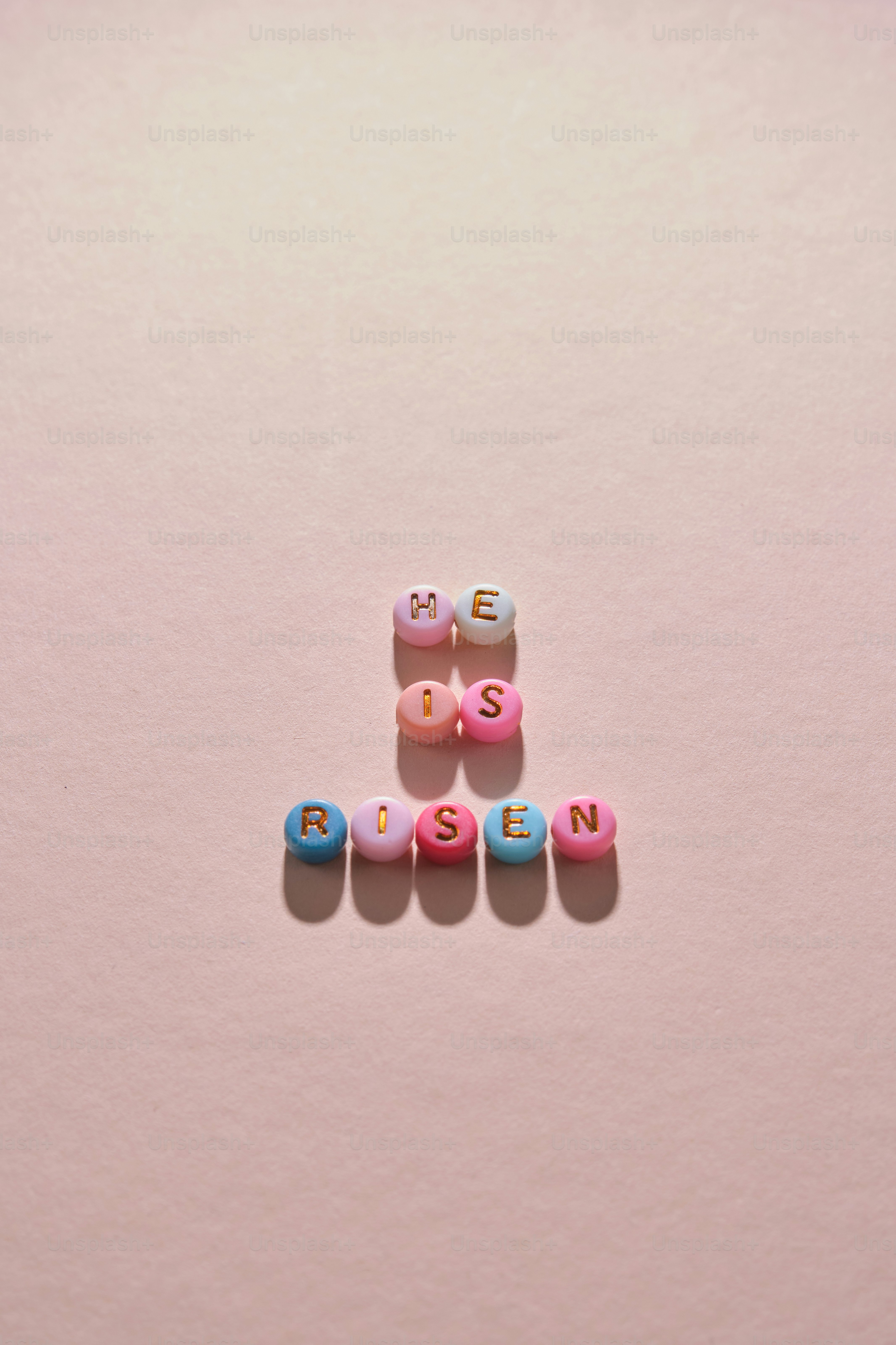 He is risen spelled with colorful beads