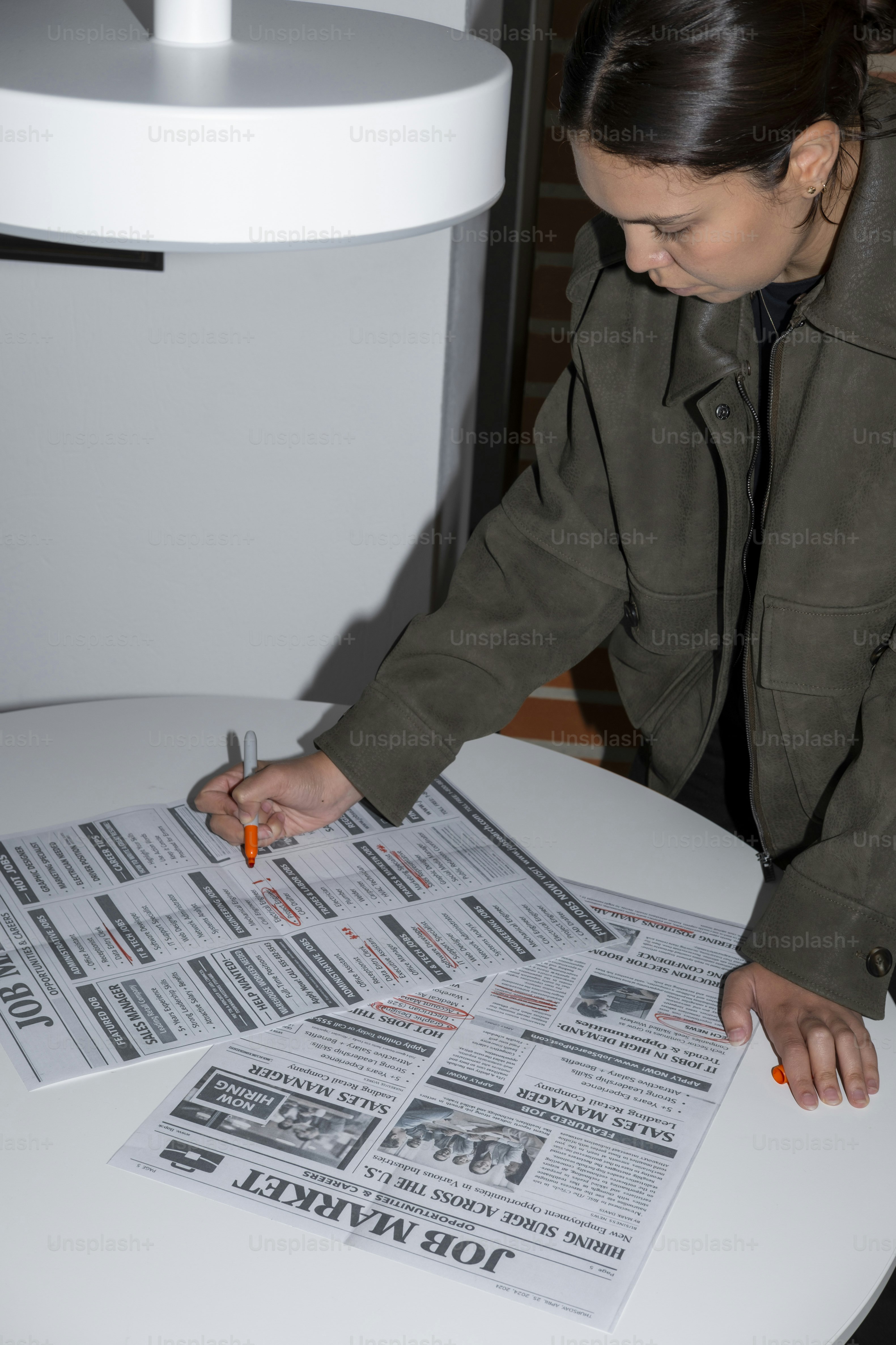 Woman marking job listings in newspaper photo – Business Image on Unsplash