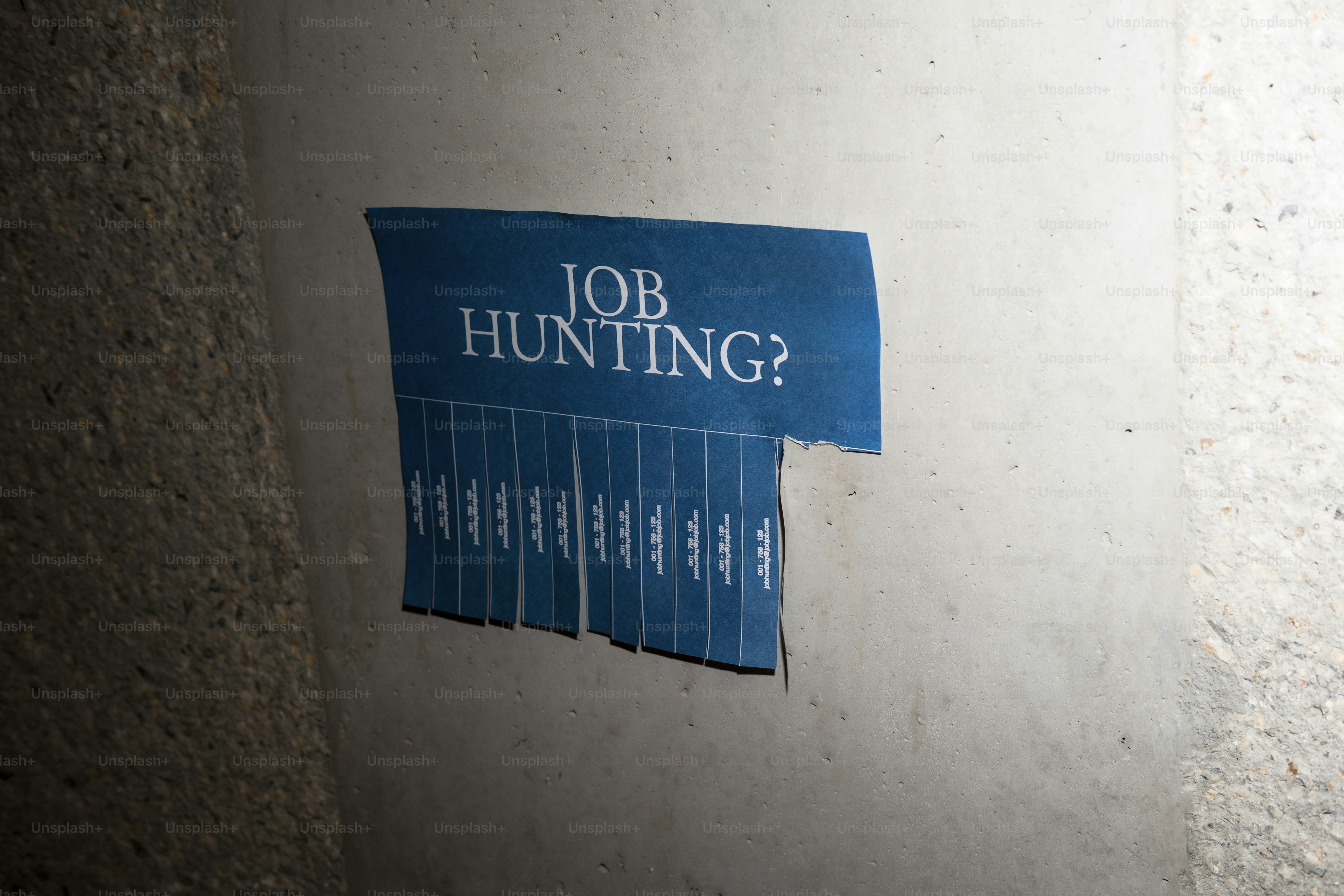 Job hunting flyer with tear-off tabs on wall