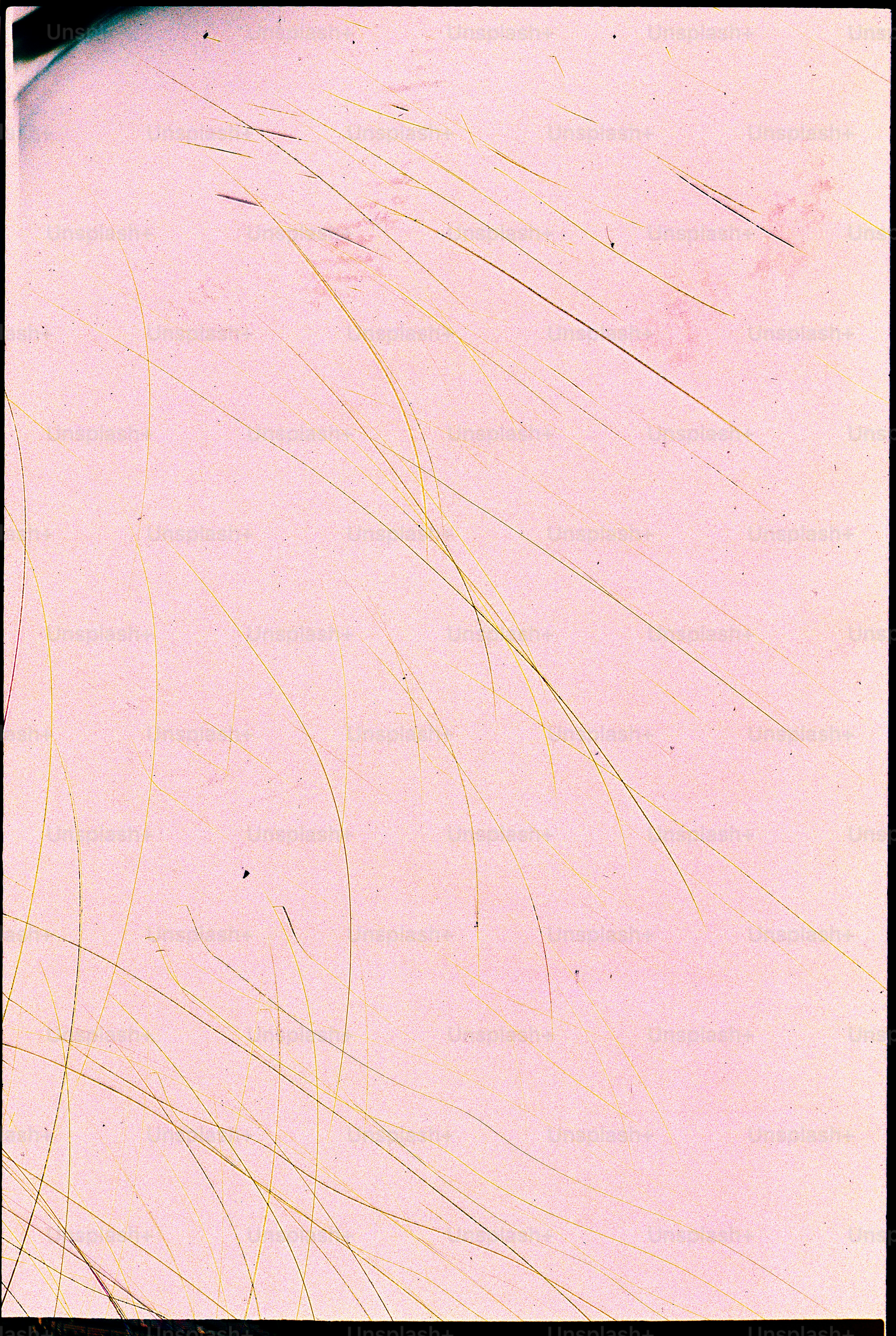 Pink background with thin, light-colored scratches