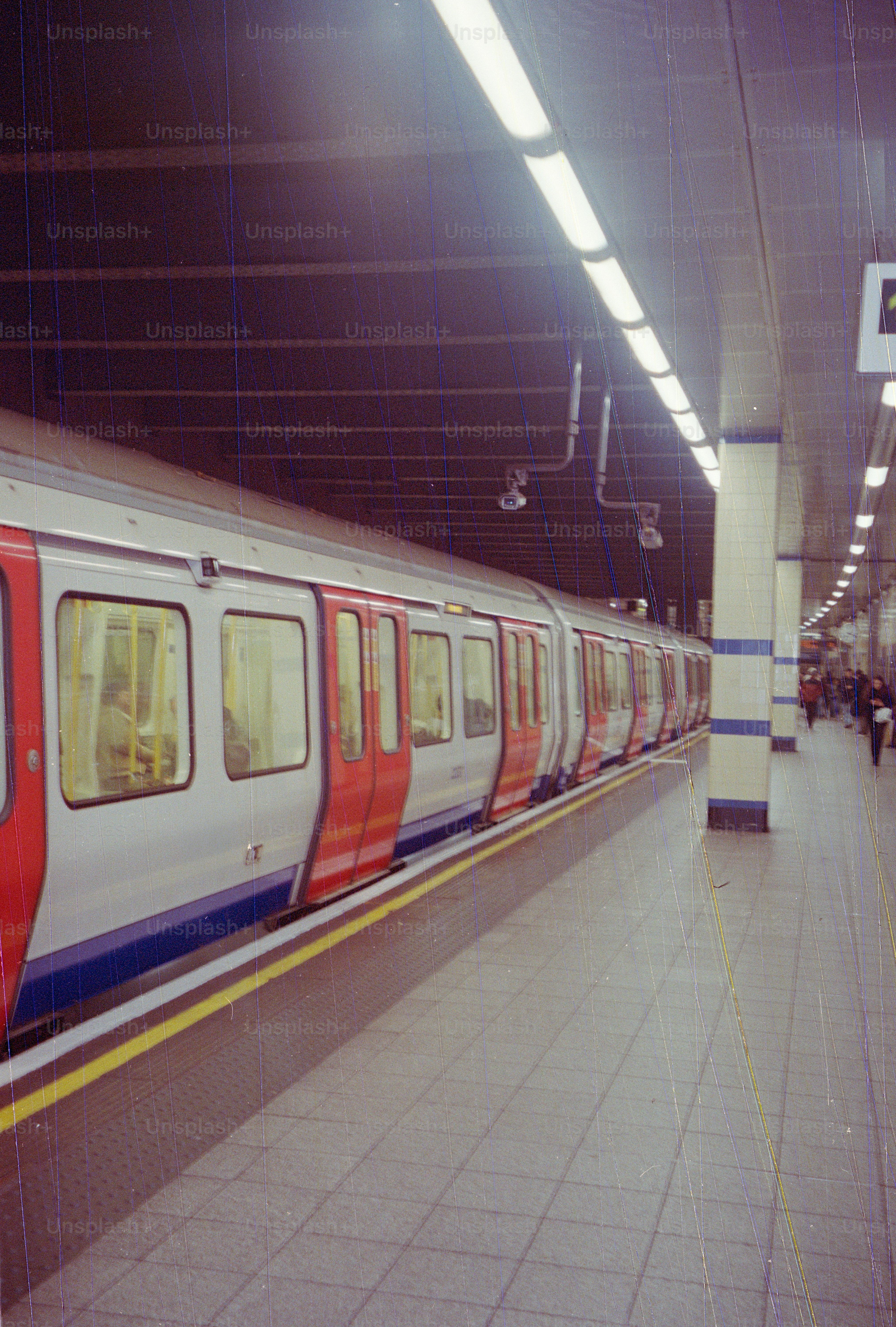 A train waits at a subway station platform.