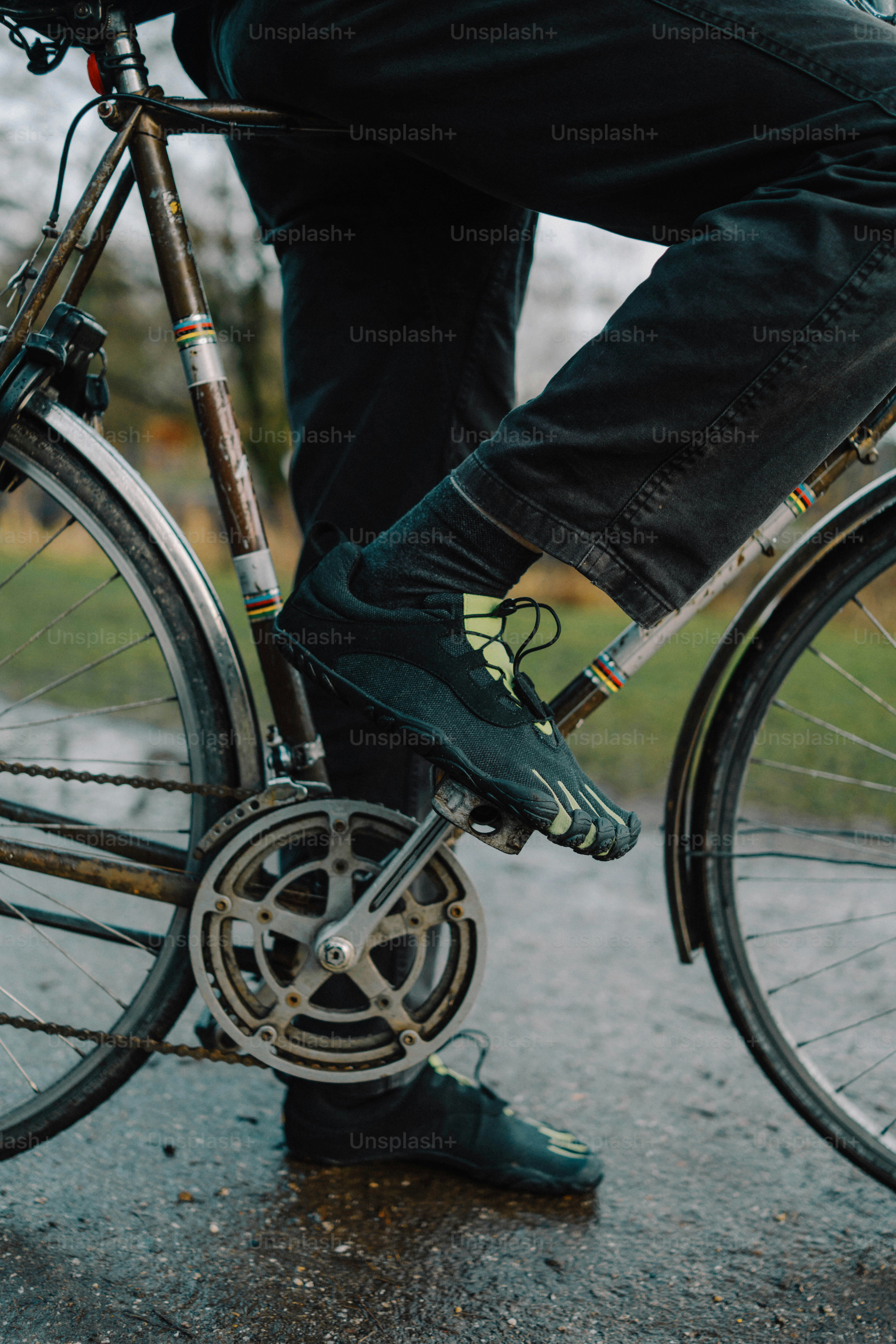 Person riding a bicycle on a wet path