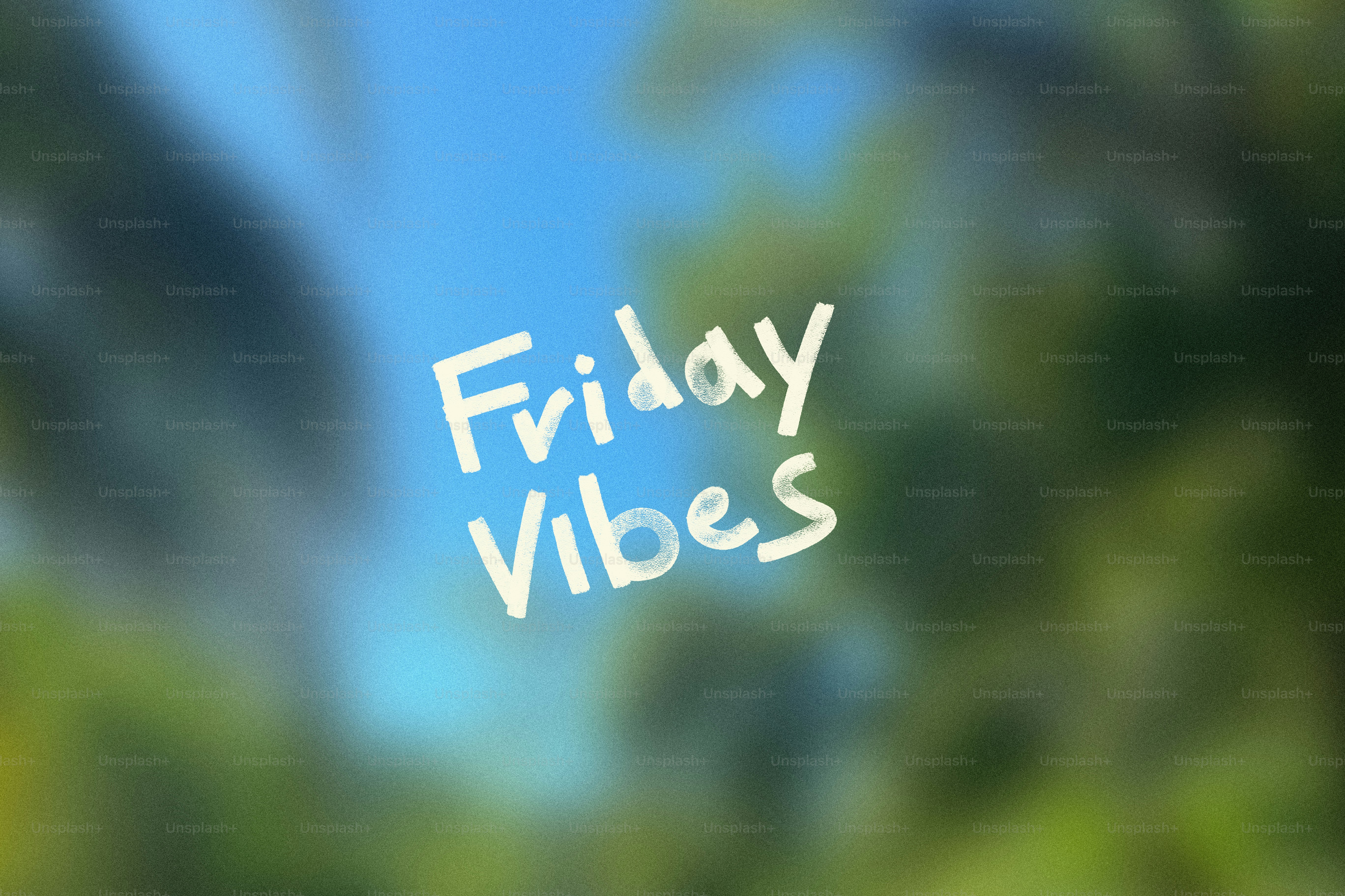 Friday vibes text with blurred green foliage background