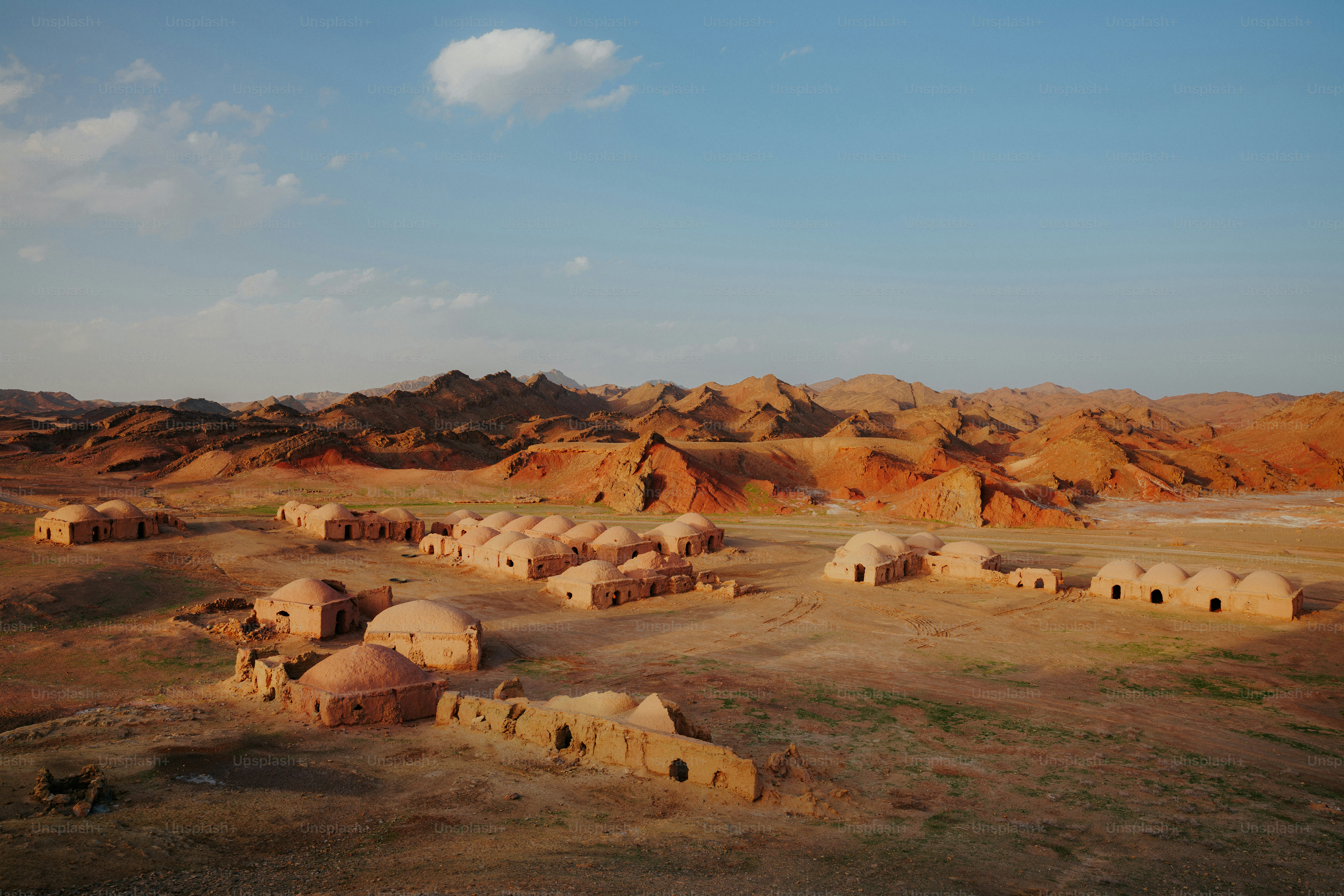 Ancient desert ruins with domed structures under a clear sky photo ...