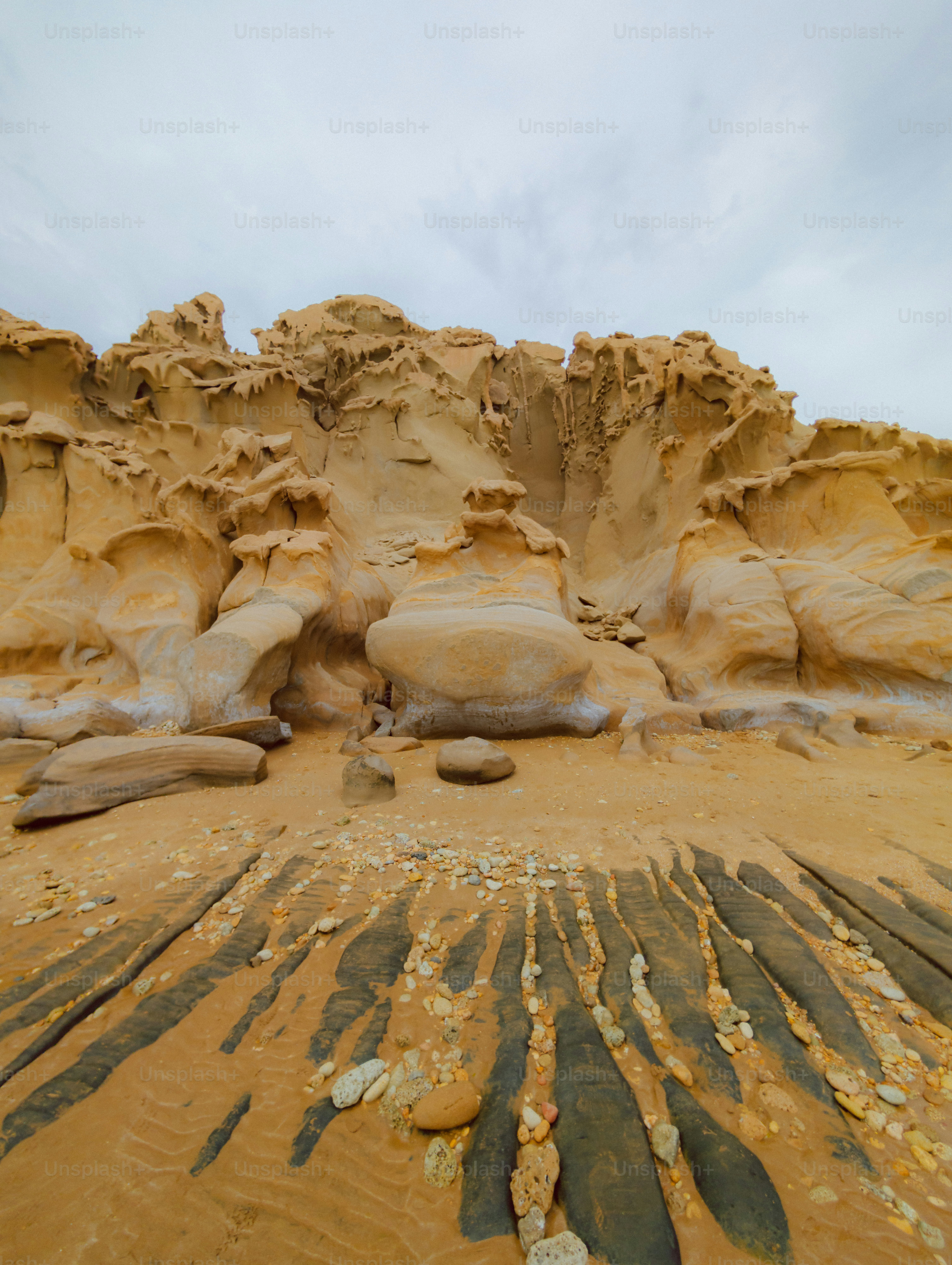 Weathered rock formations on a sandy beach photo – Adventure Image on ...