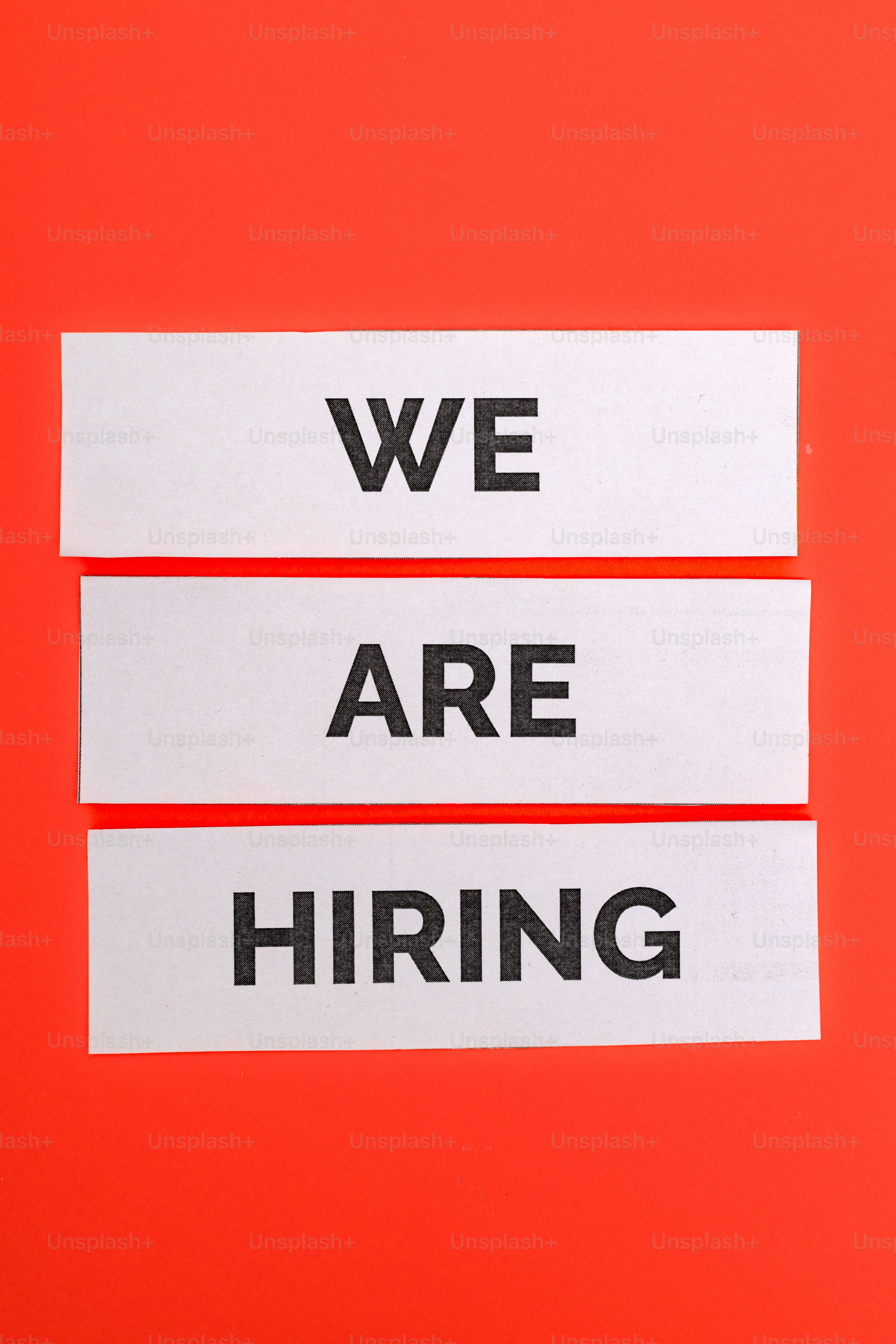 Three white paper strips with text we are hiring
