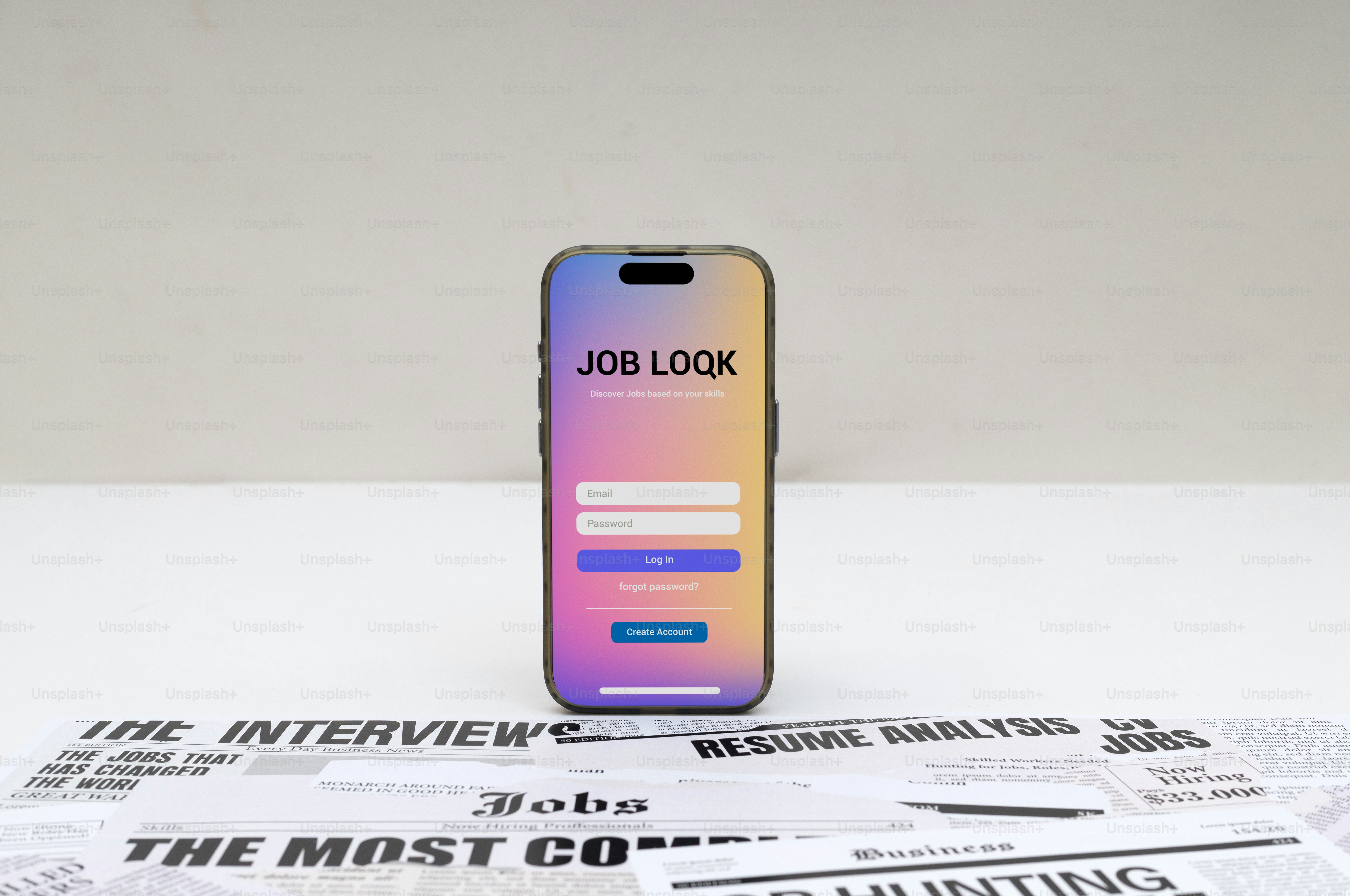 Smartphone displaying job search app interface on newspaper