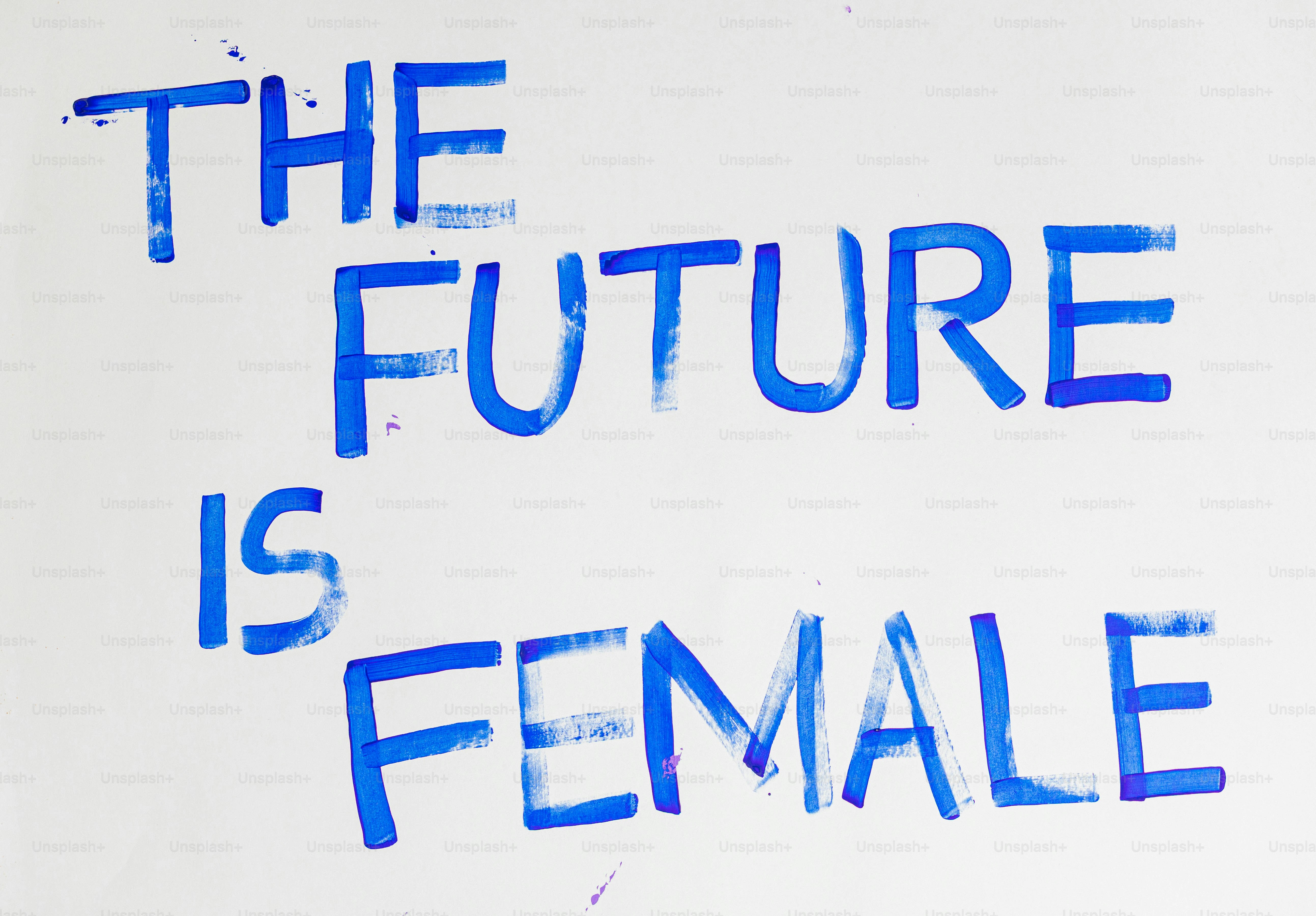 The future is female written in blue paint