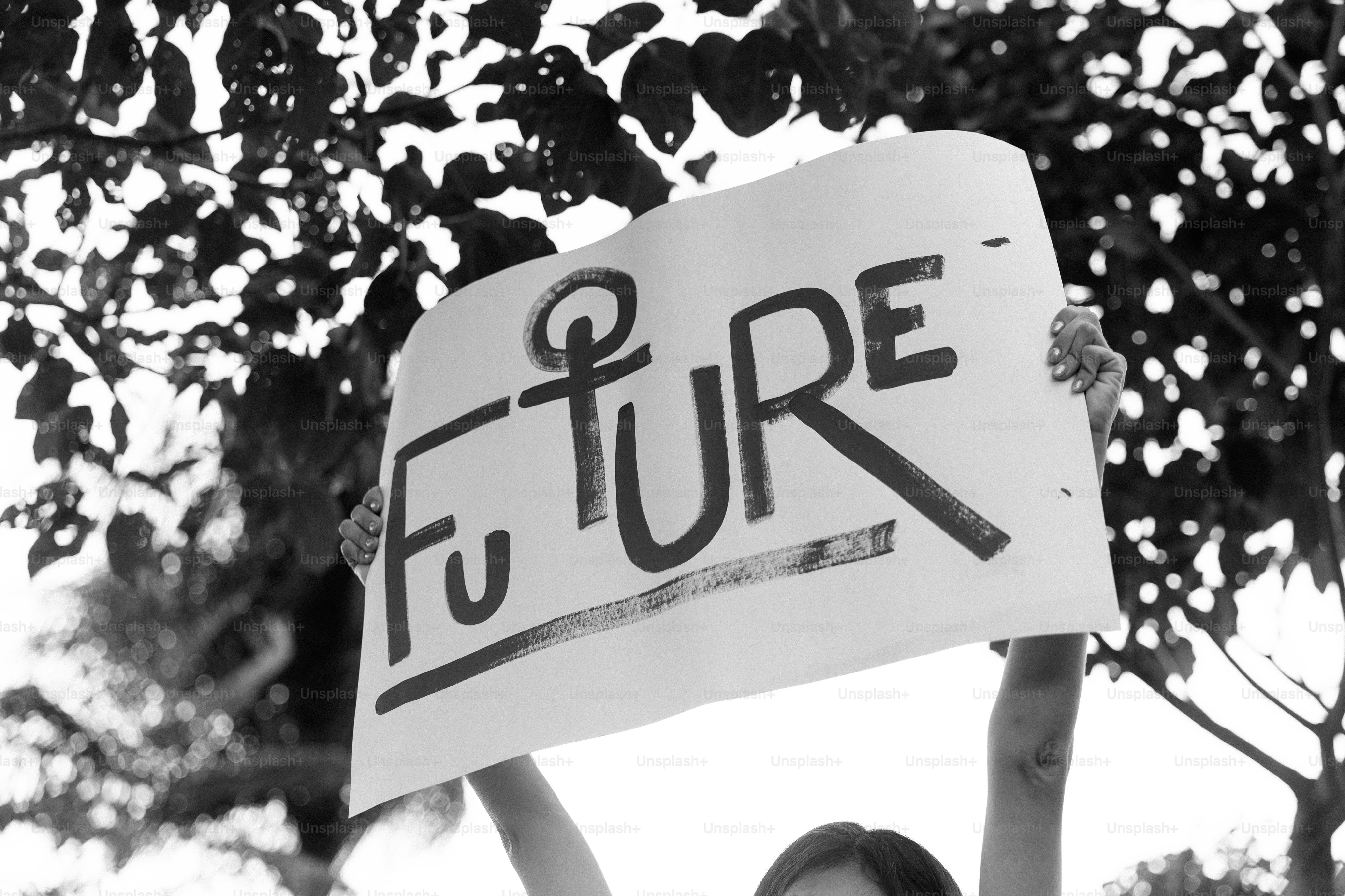 '미래'라는 단어가 적힌 팻말을 든 사람이