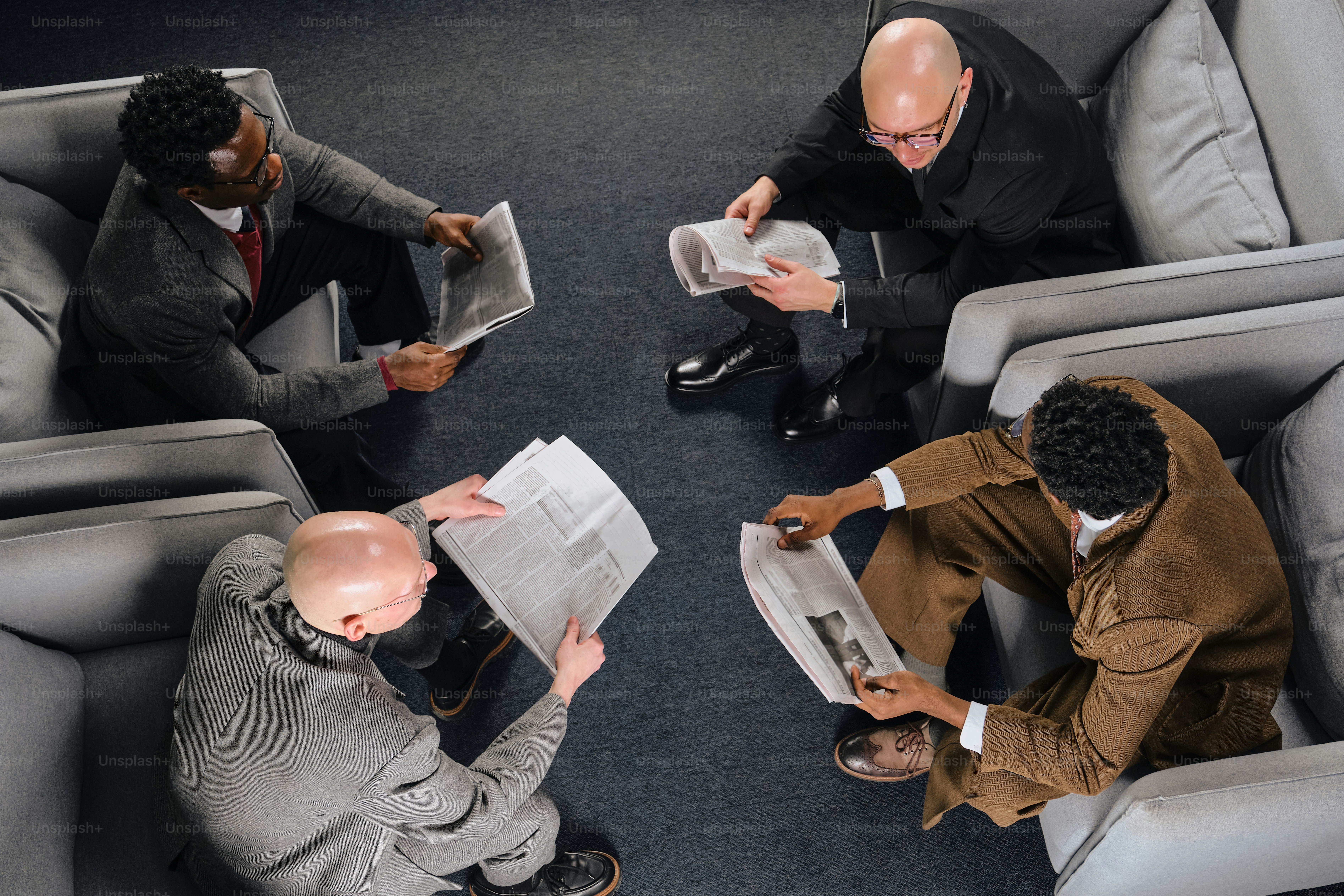 Three men in suits reading newspapers in chairs. photo – Business ...
