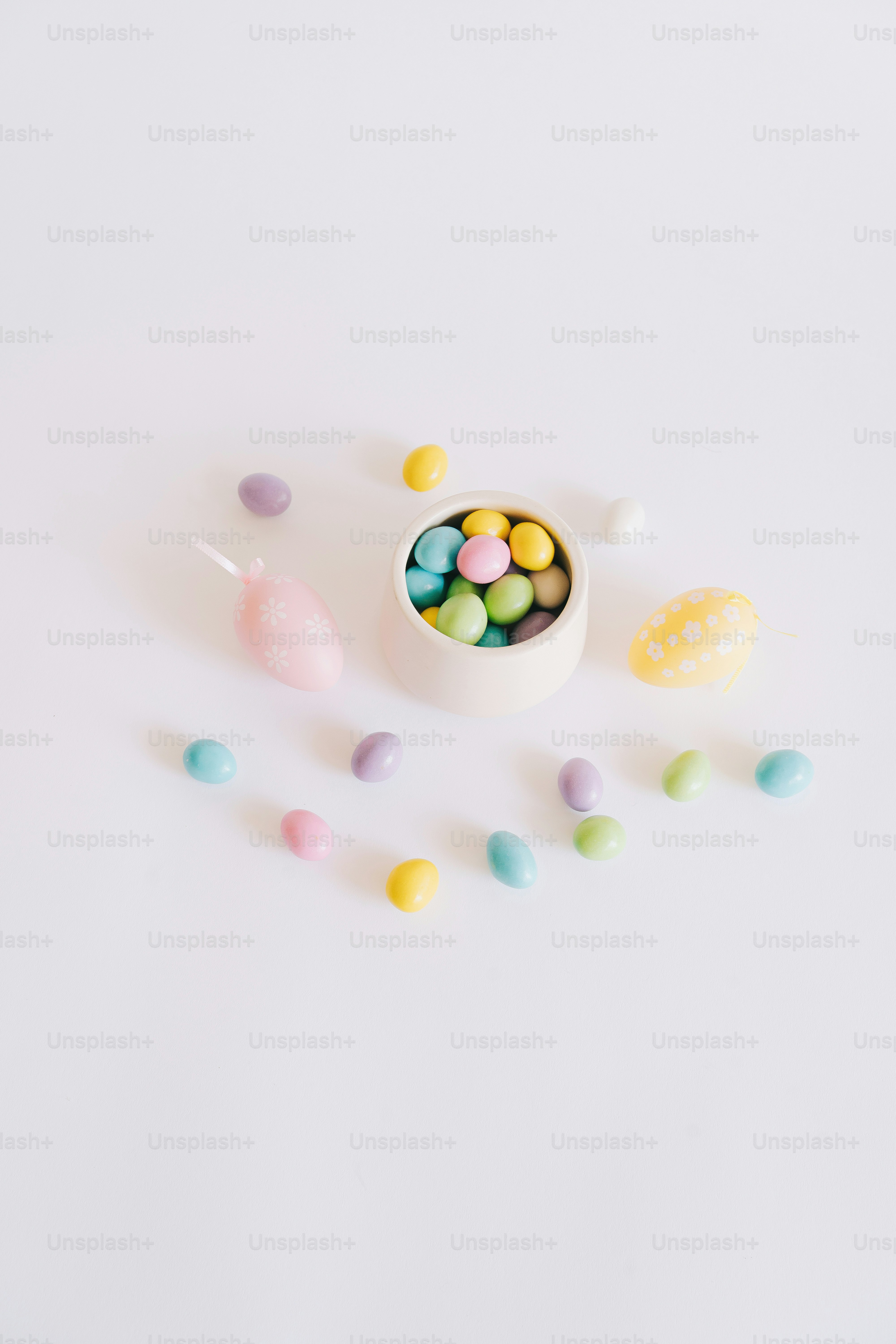 Pastel candies and easter egg on white background