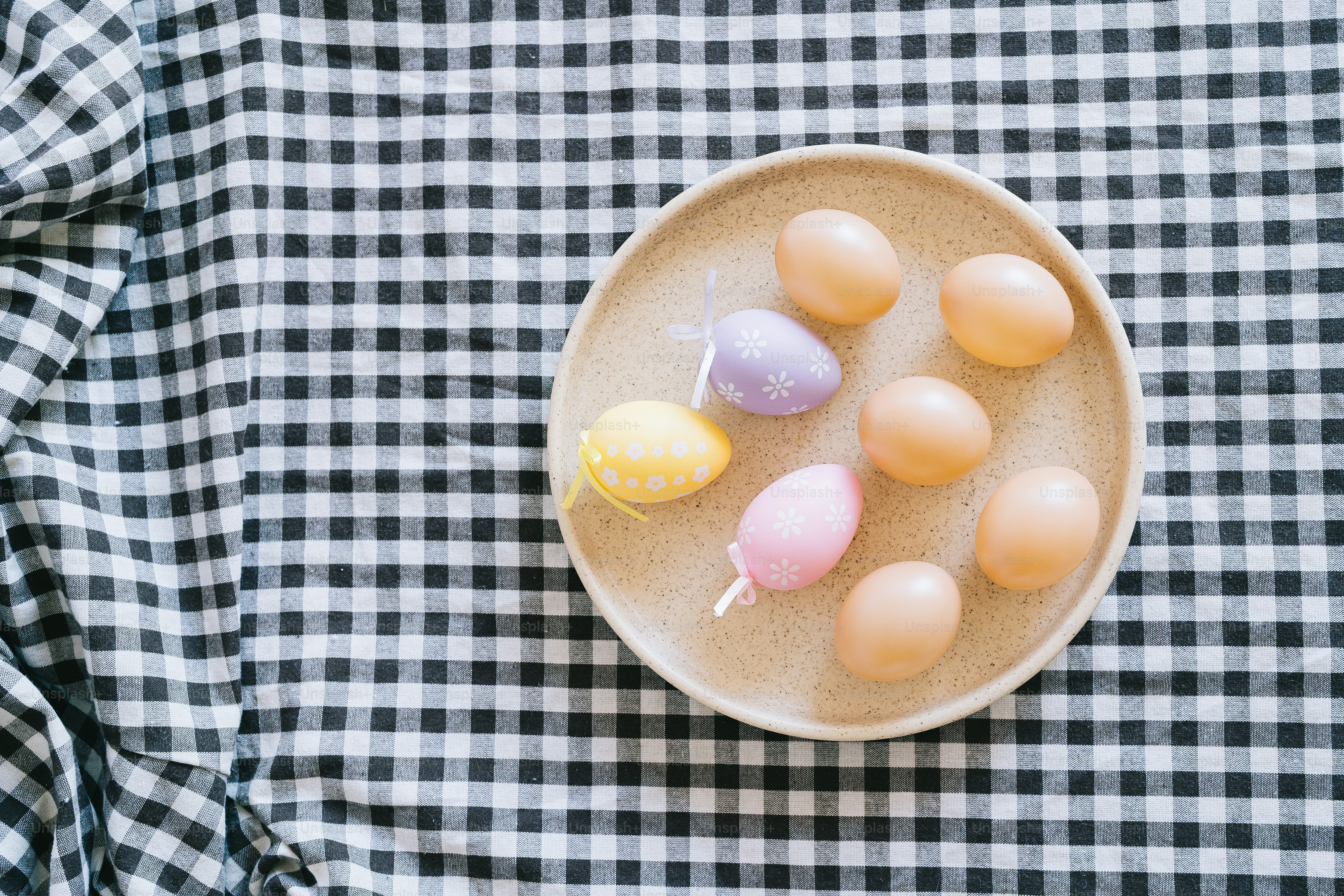 Easter eggs on a plate with checkered cloth