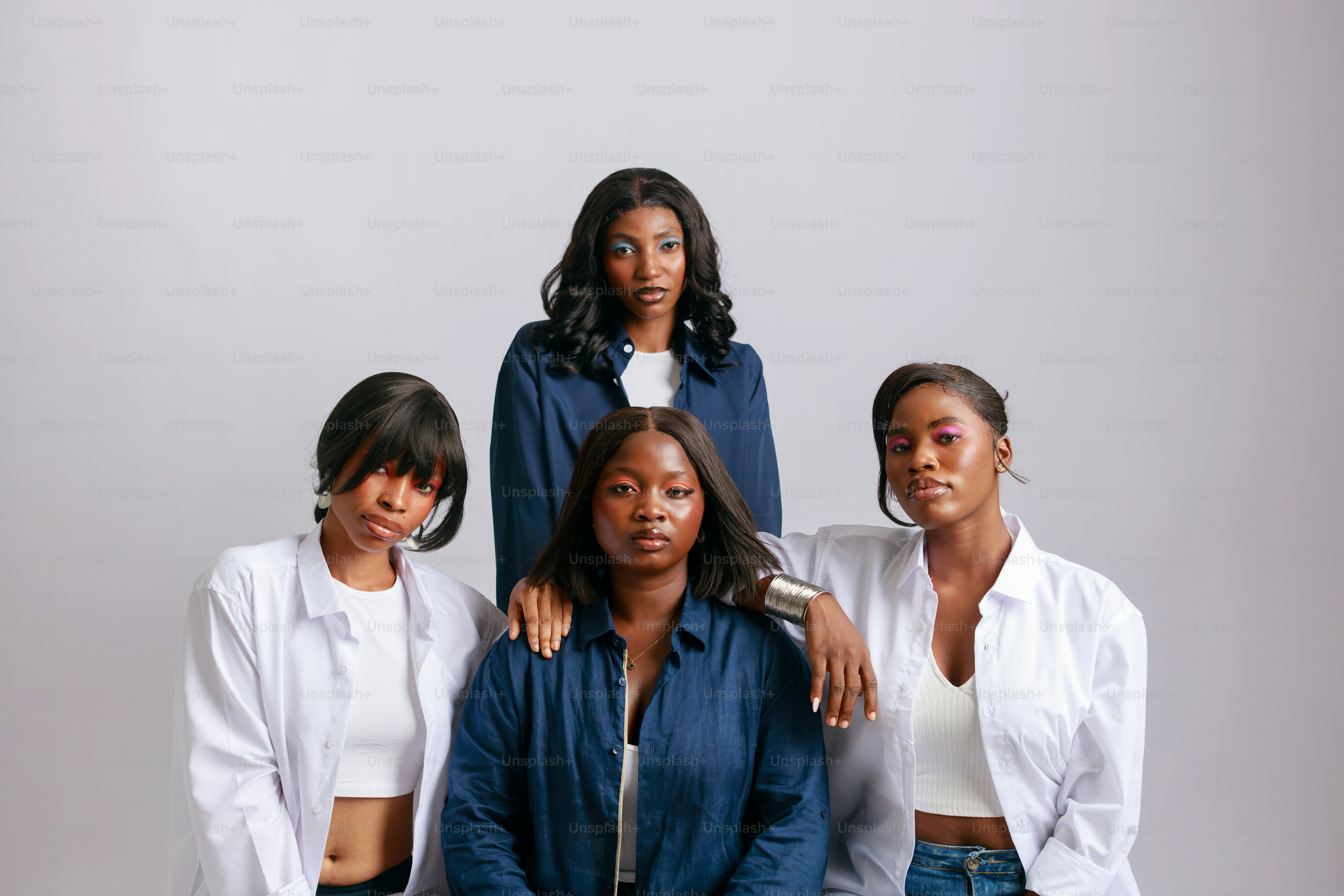 Four women posing against a white background