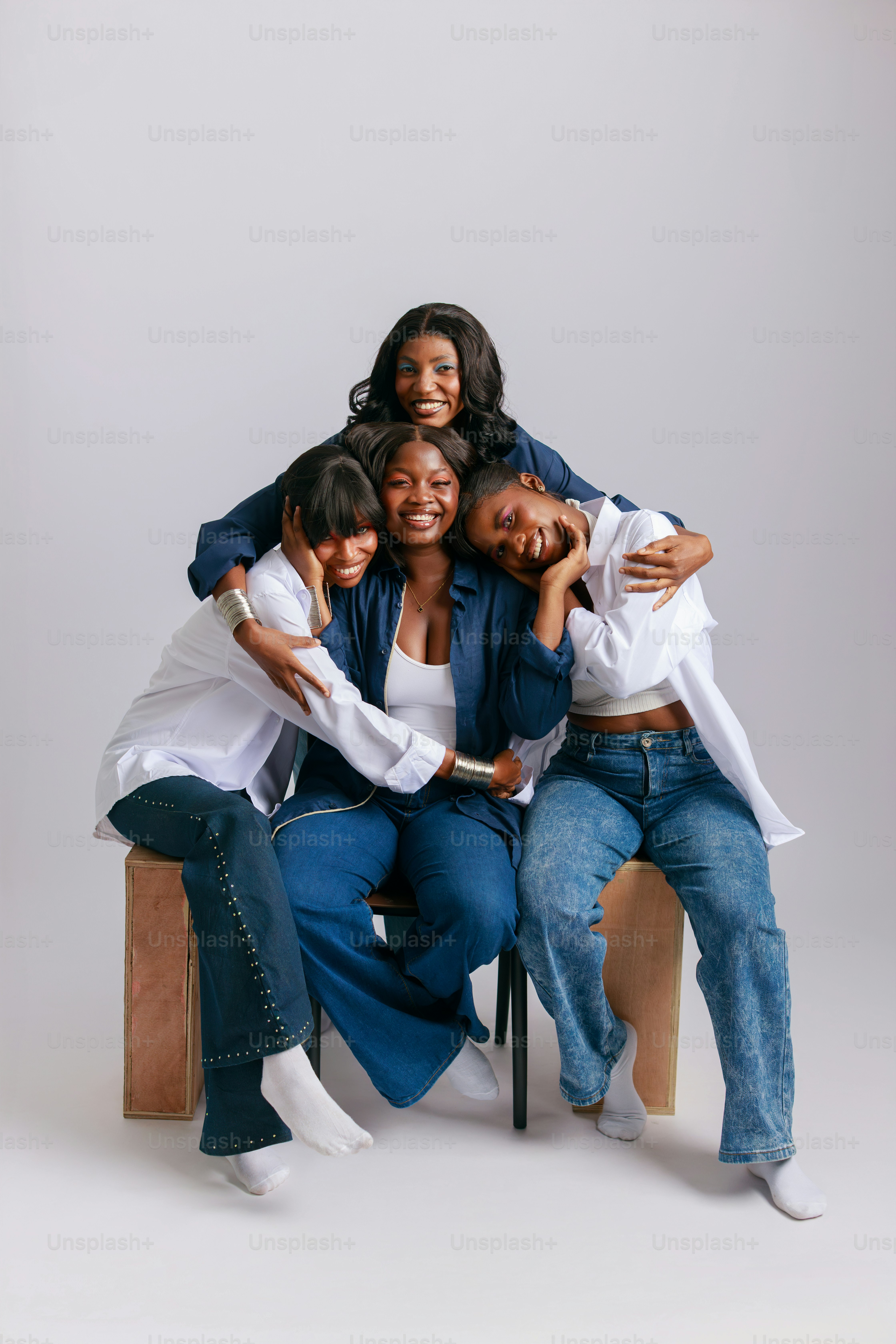 Four smiling women hugging each other