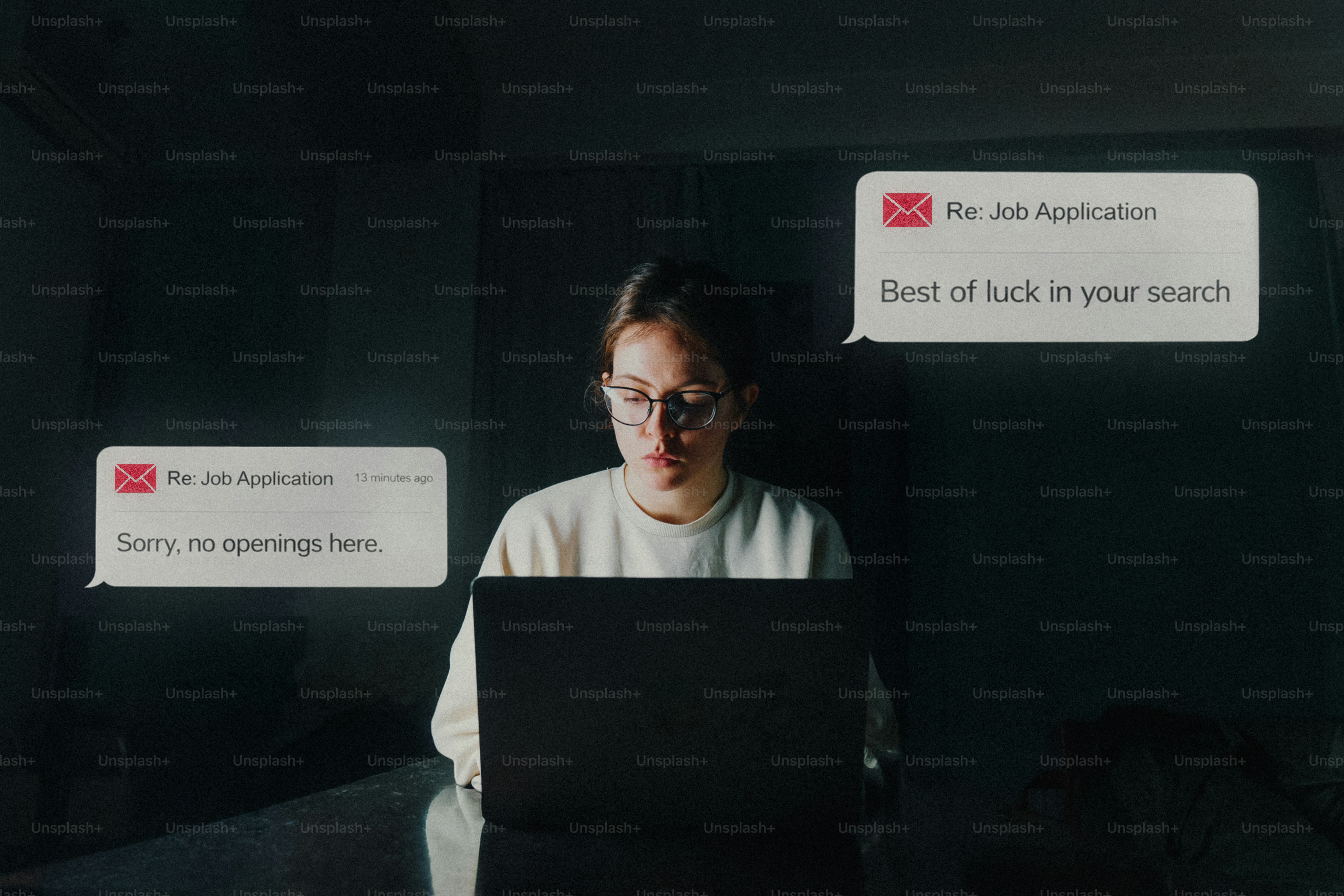 Woman looking at job rejection messages on laptop.