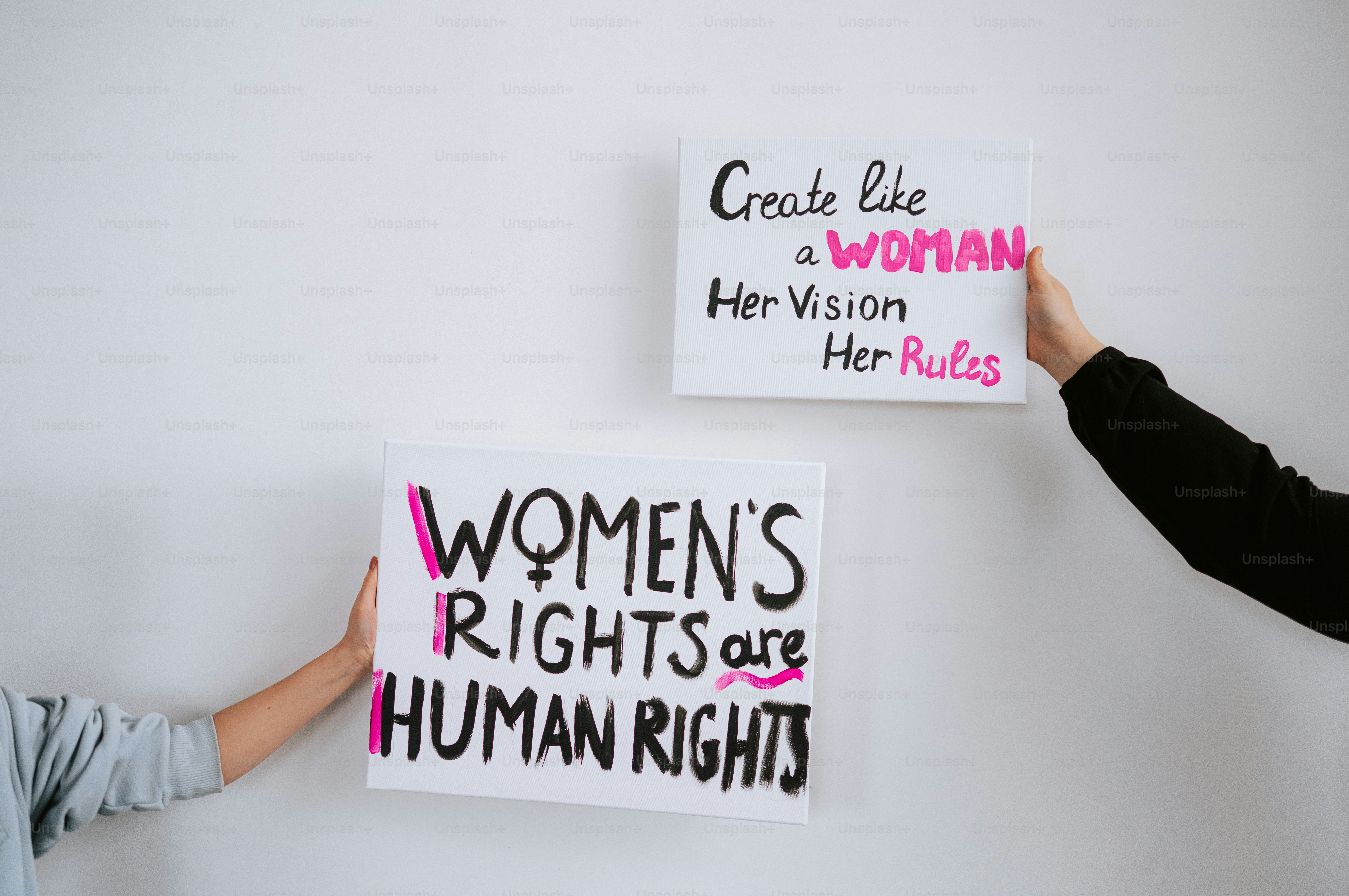 Two signs advocating for women's rights and empowerment.