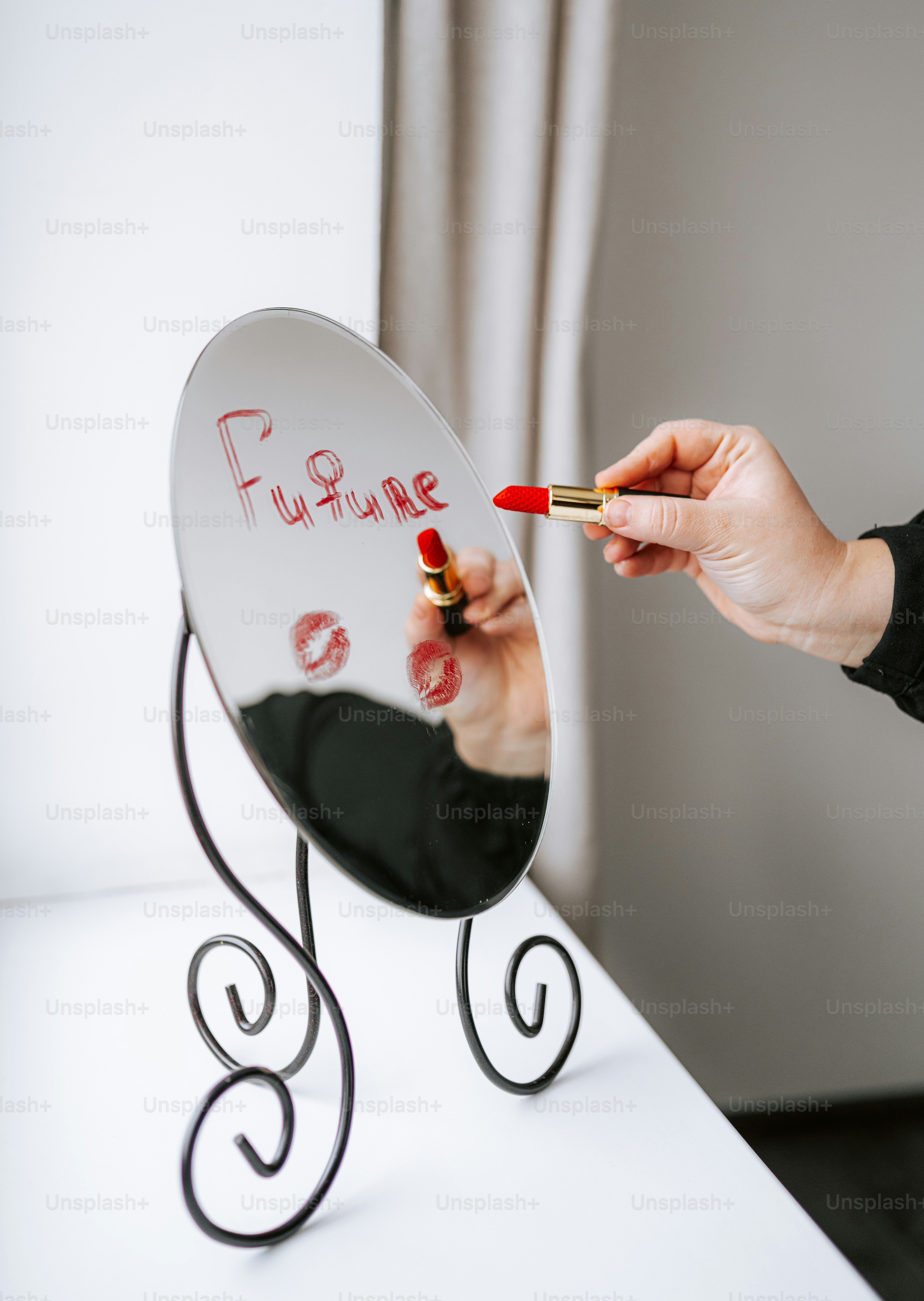 Hand writing "future" on mirror with lipstick