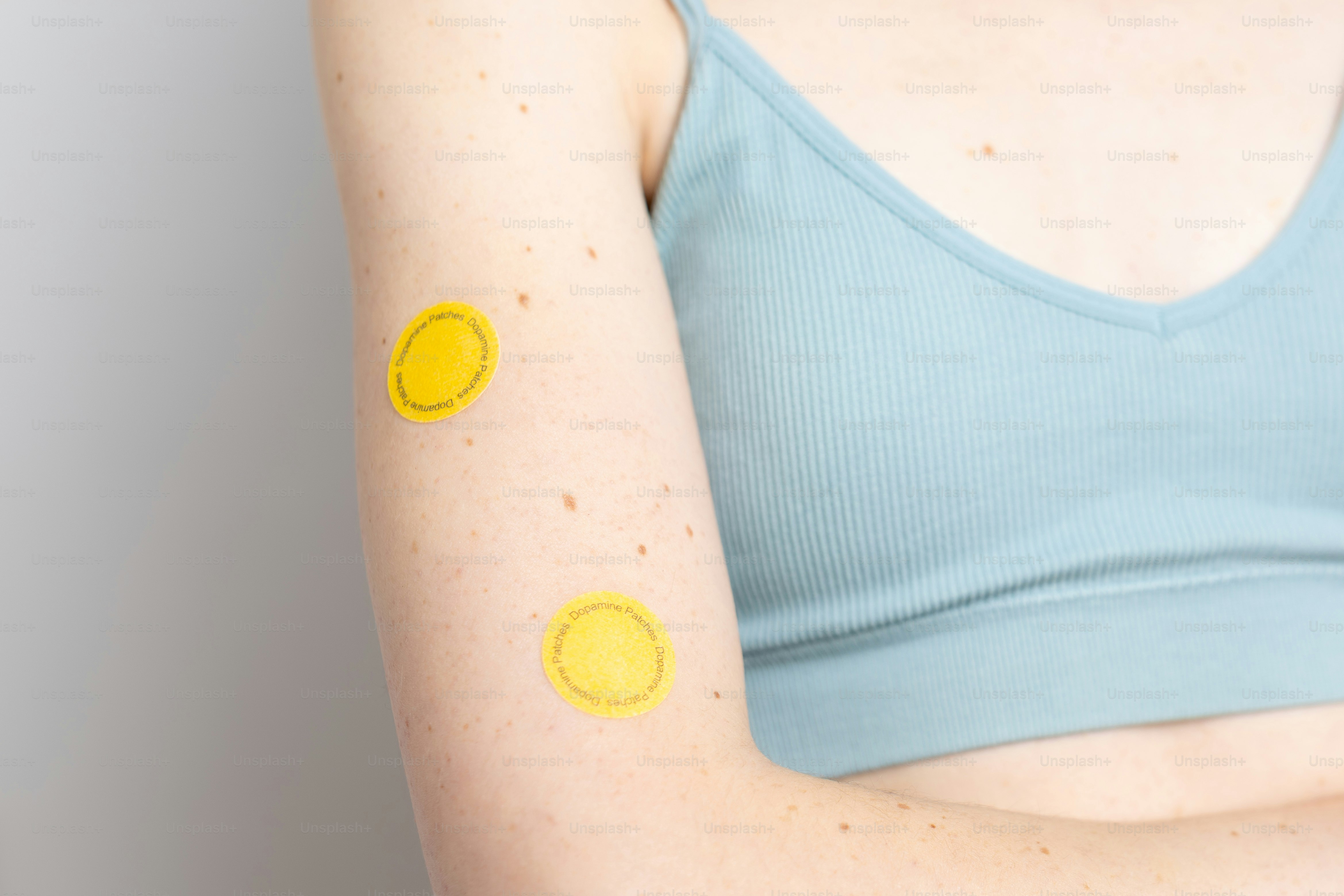 Two yellow circular patches on an arm photo – Health Image on Unsplash