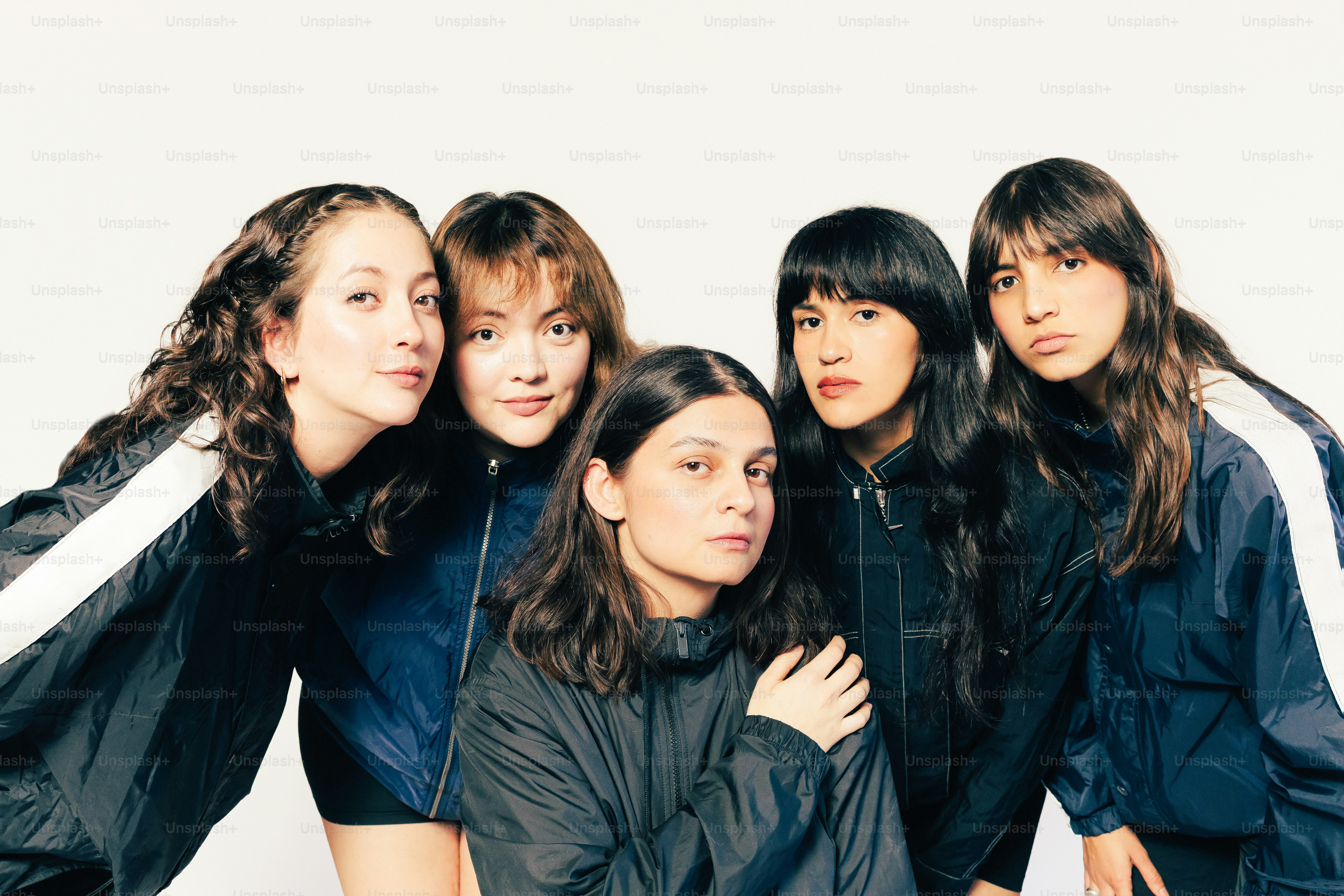 Cinco jóvenes con ropa deportiva posando juntas